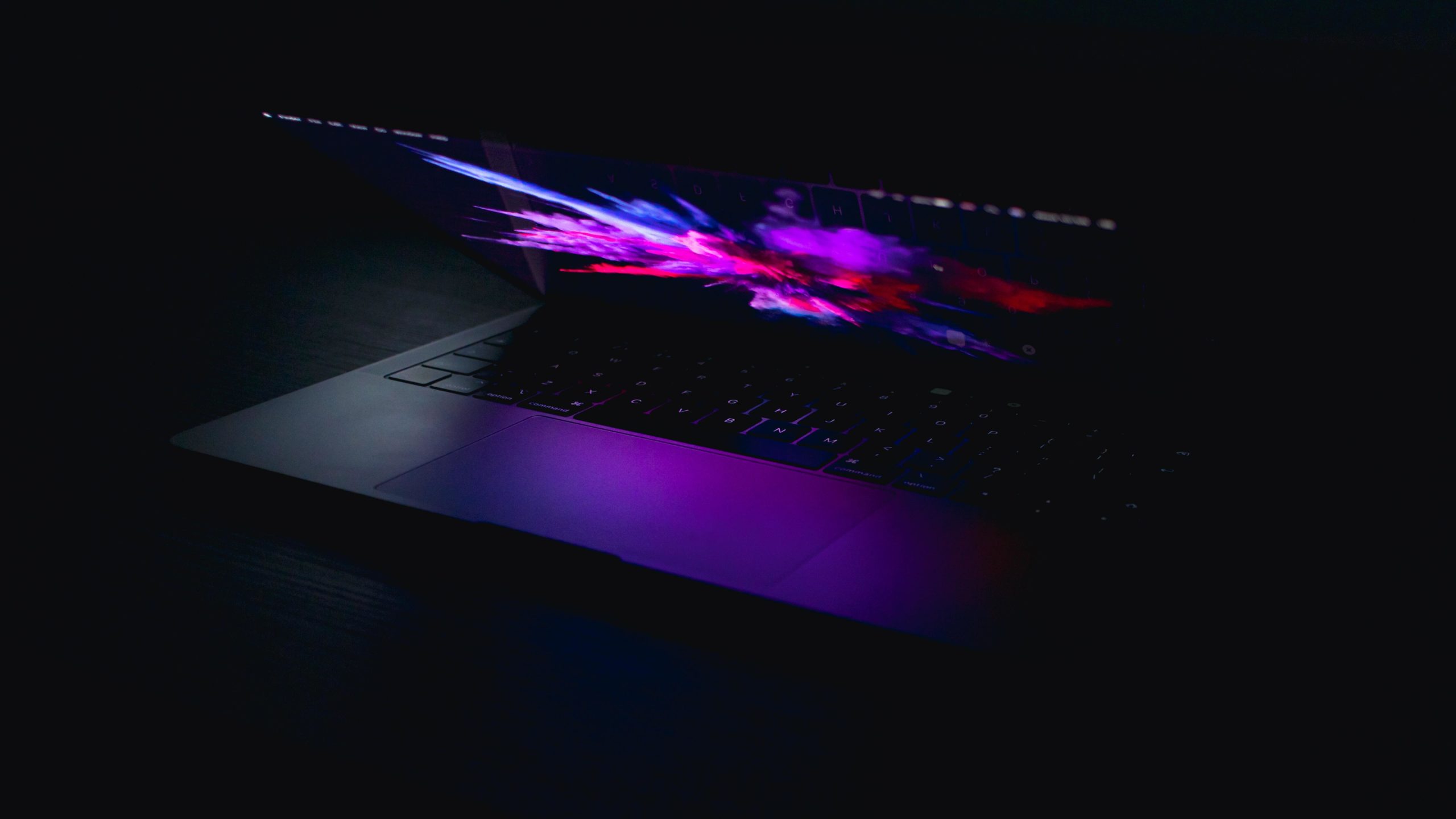 Laptop lit up in dark room