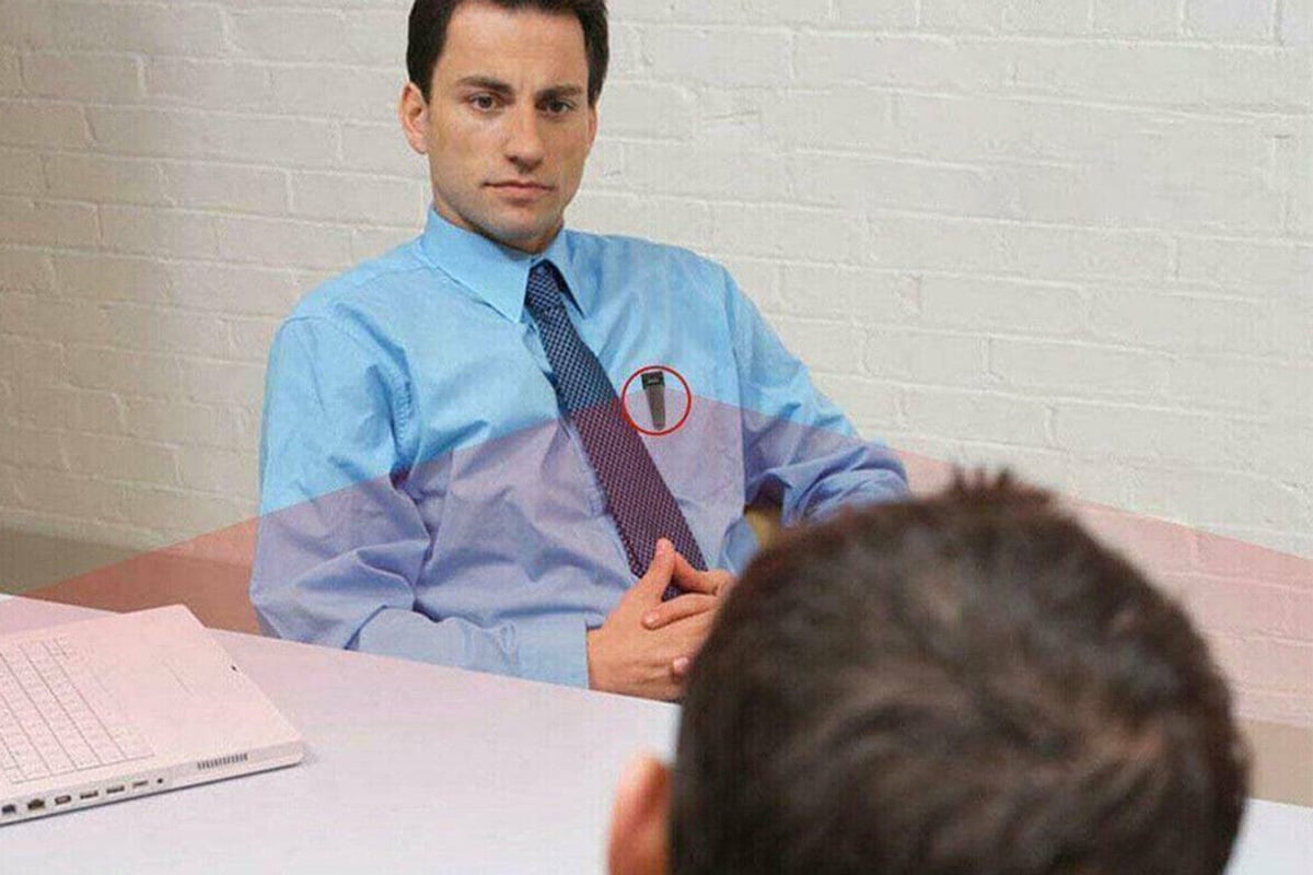 Man conversing with camera in his shirt pocket