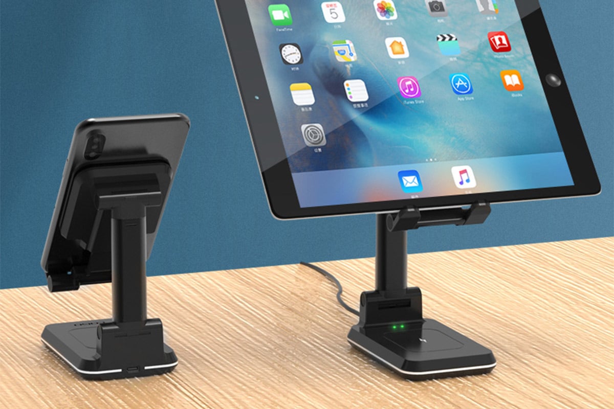 smartphone on one stand and a tablet on the other.