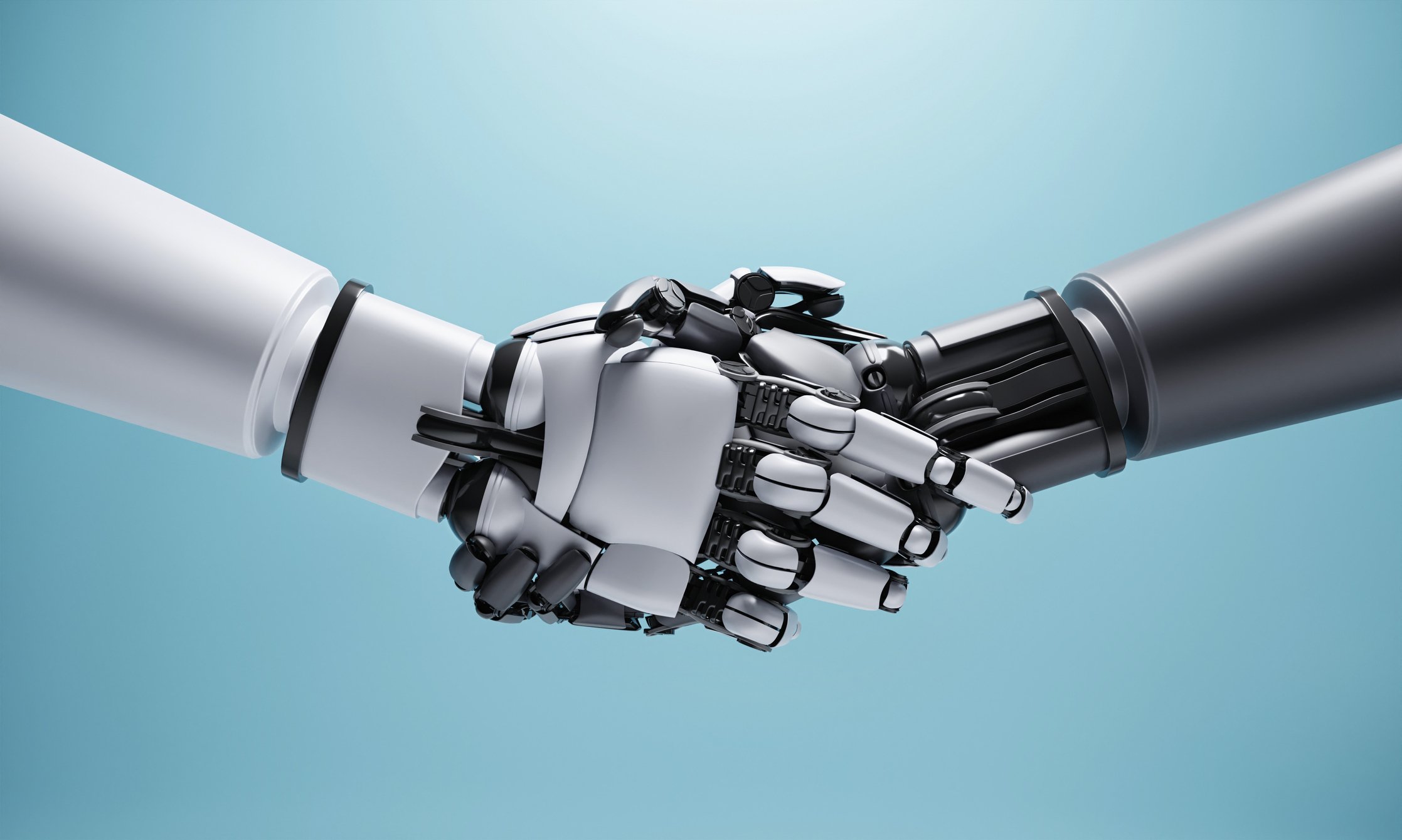 two robotic arms shaking hands