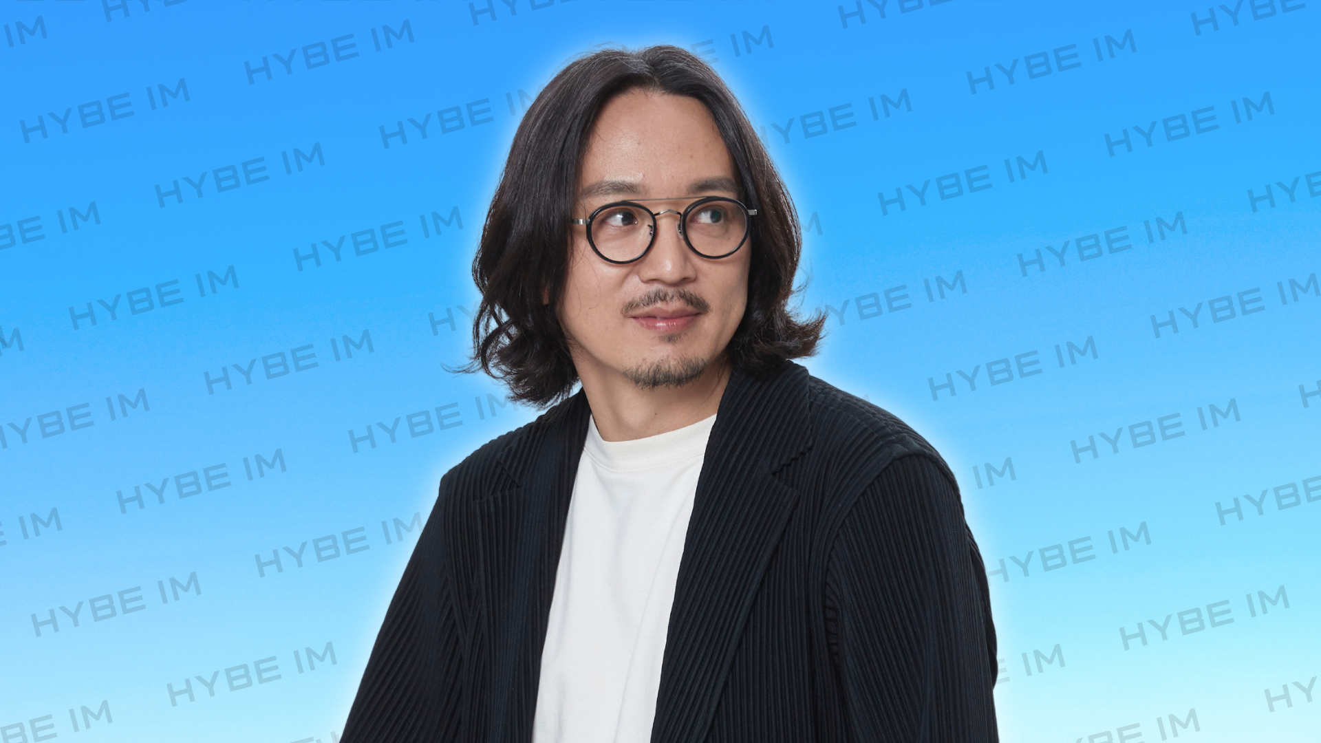 HYBE IM CEO Jung in a white tee and black blazer.