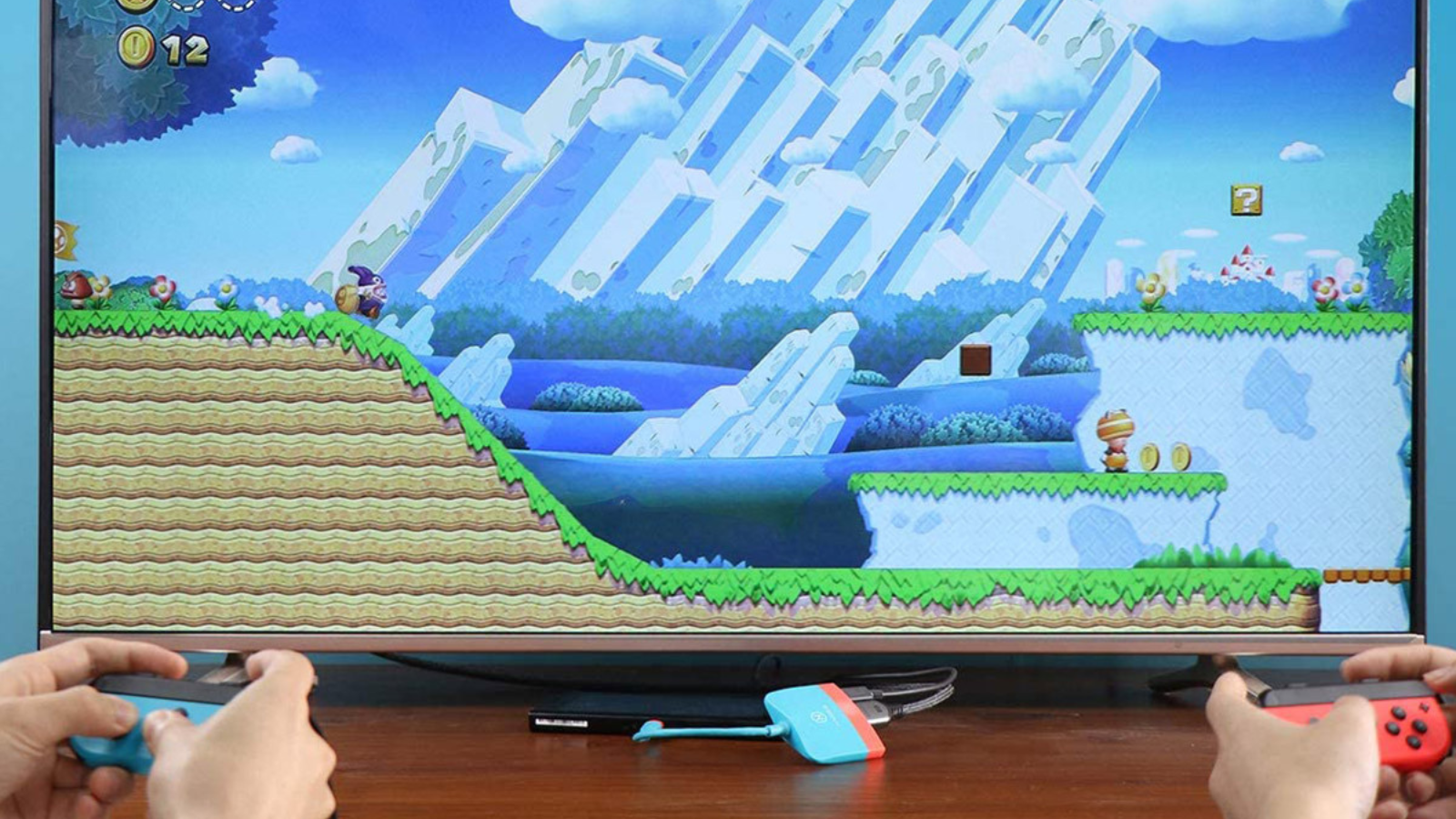 close up of video game on tv with two people holding controllers and using nintendo switch docking station