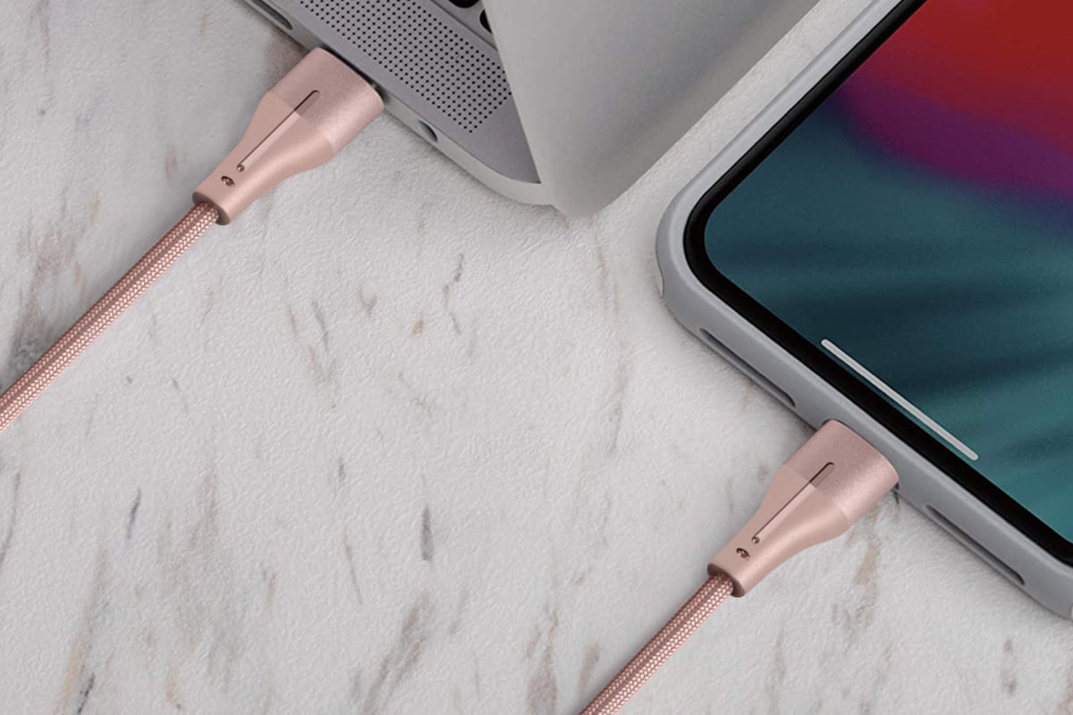 Pink lightning charging cable plugged into a tablet
