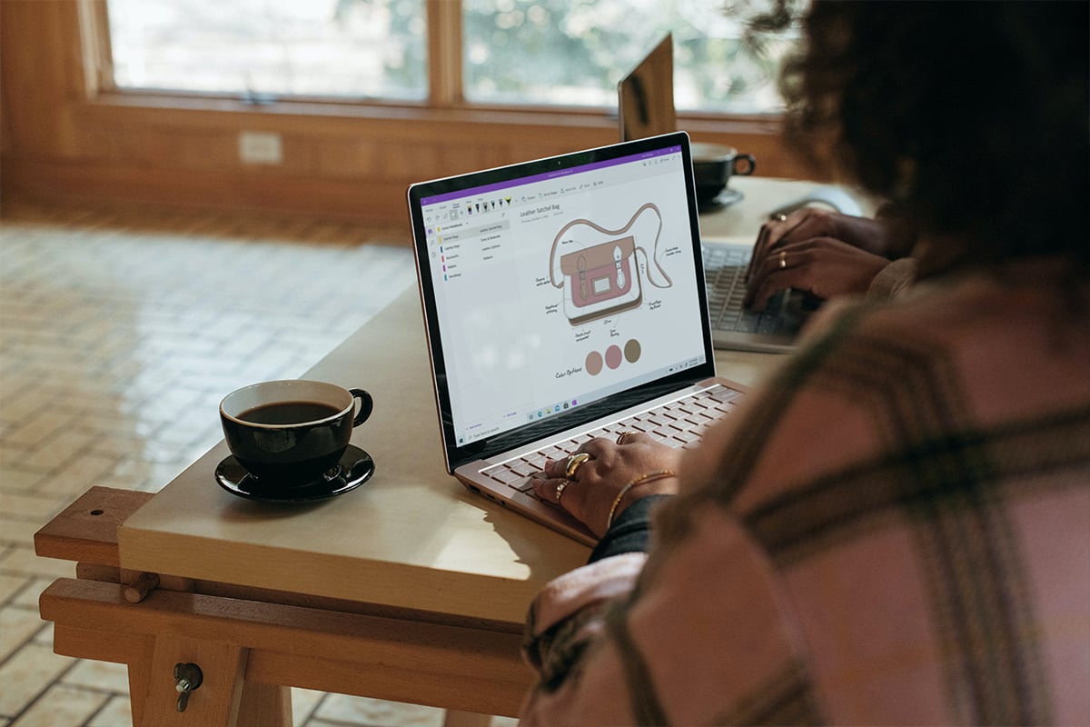 woman using a laptop in a coffee shop