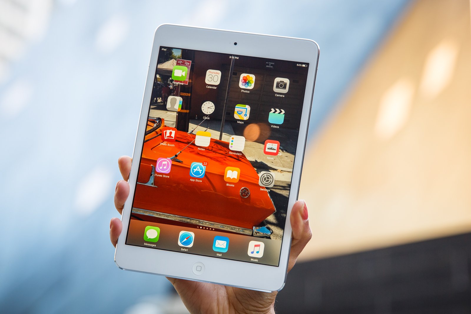 iPad mini 2 being held up in someone's hand.