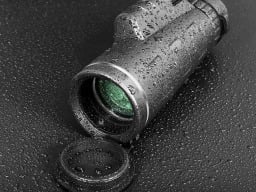 monocular telescope with green lens, wet