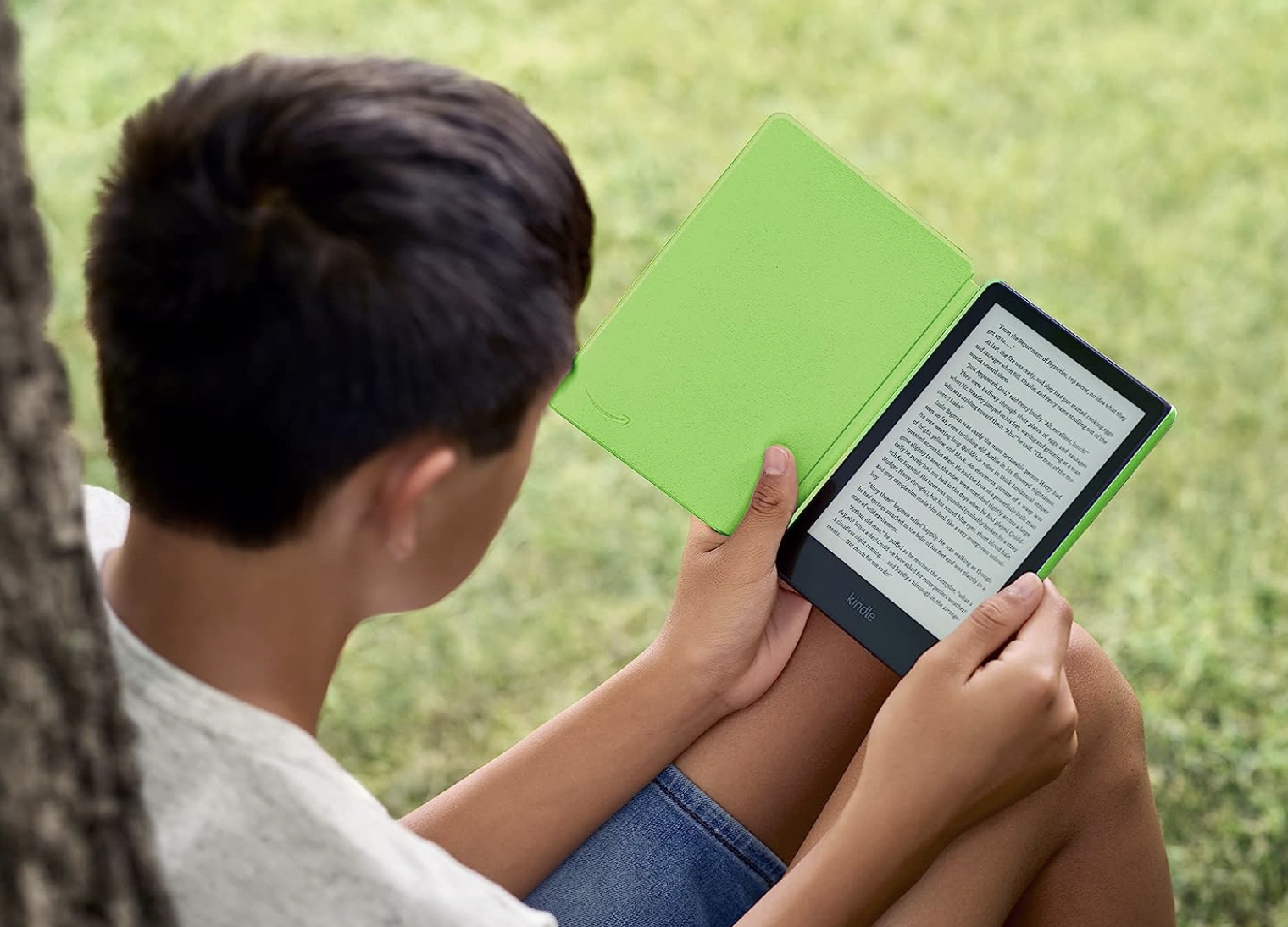A boy reading a Kindle Paperwhite Kids