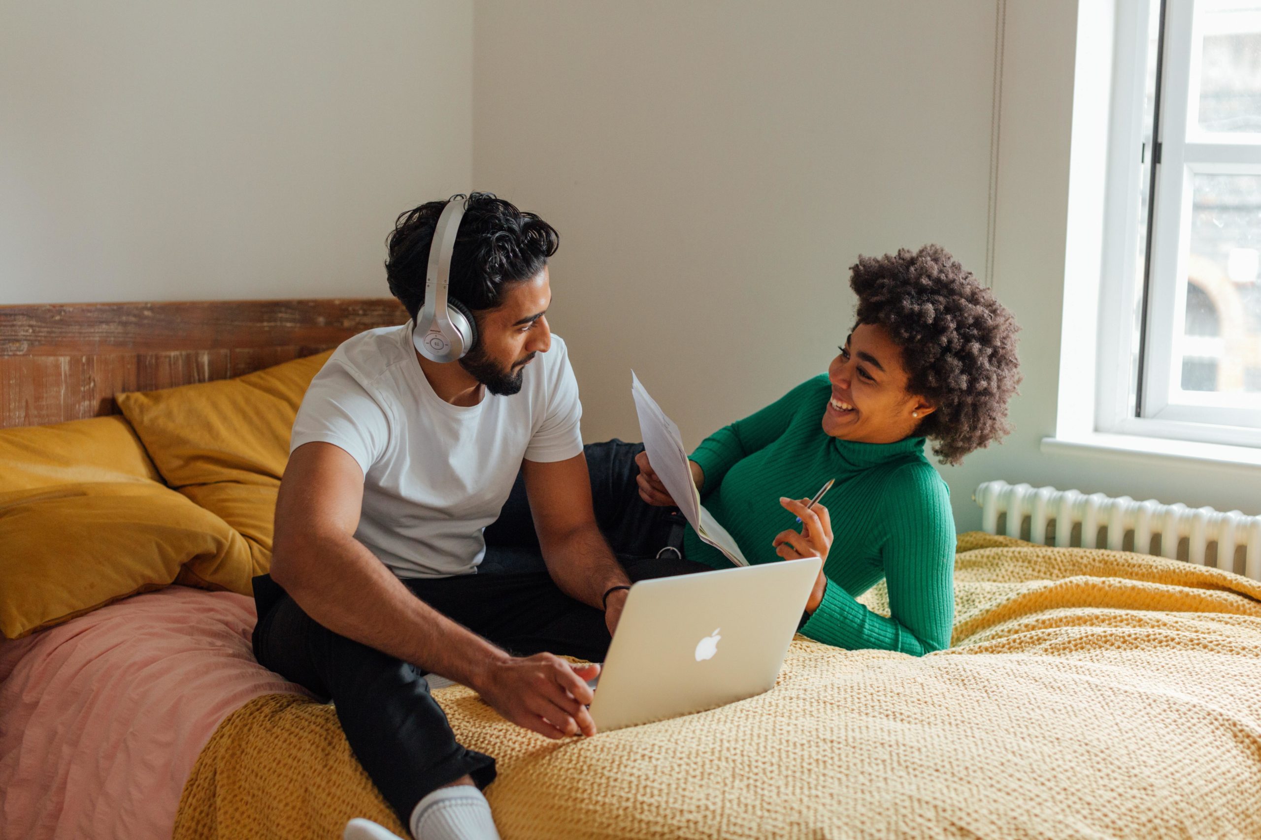 Couple on bed with laptop