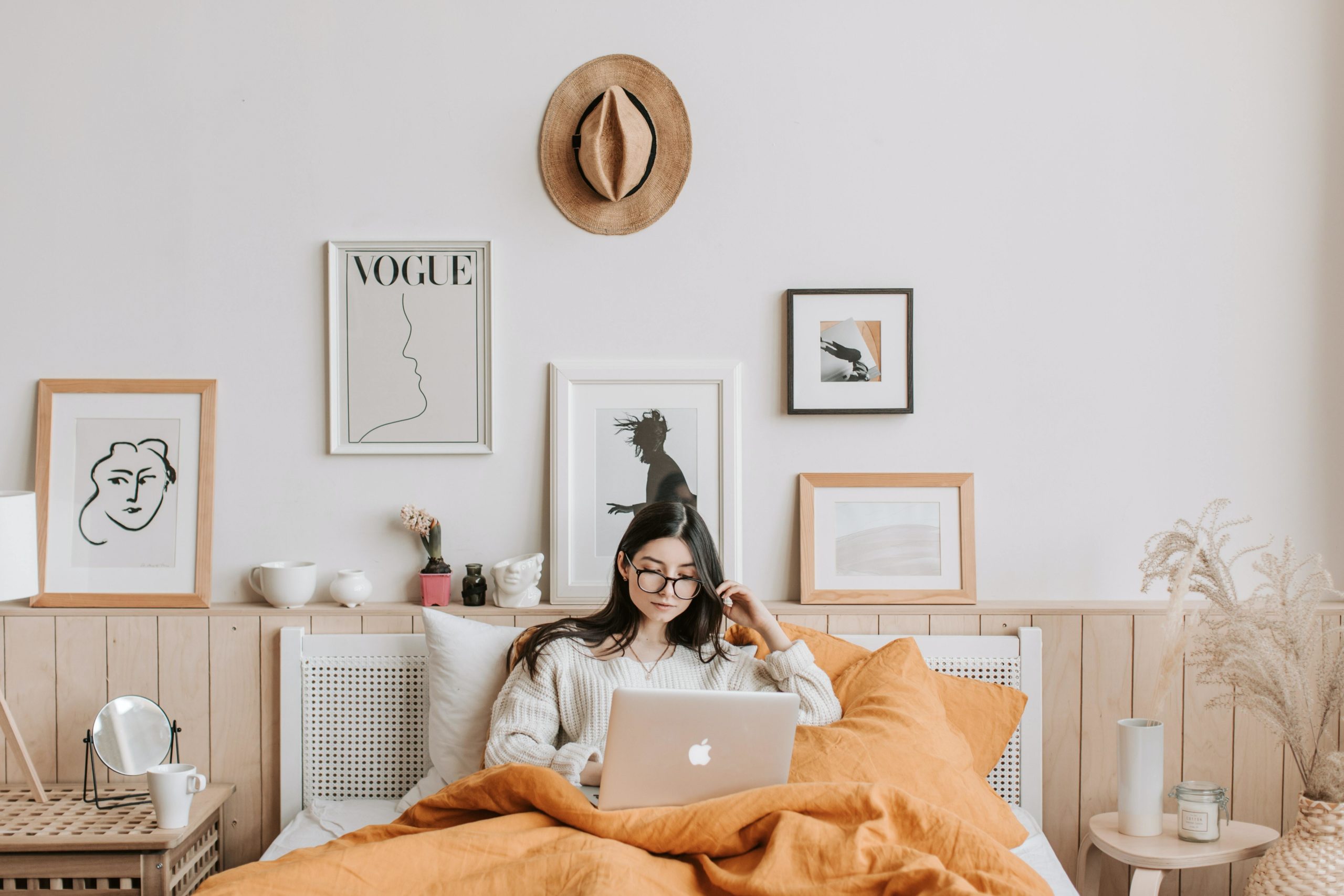 Girl looking at laptop in bed