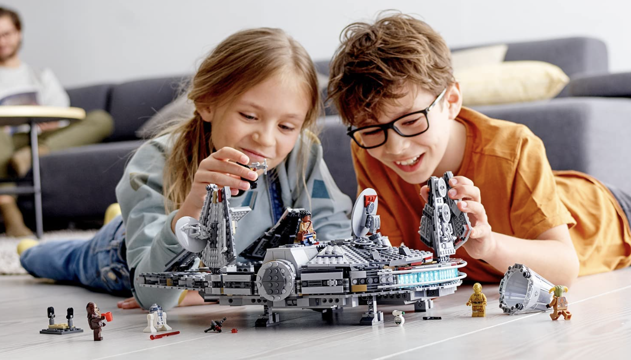 Kids playing with a Lego Star Wars Millennium Falcon