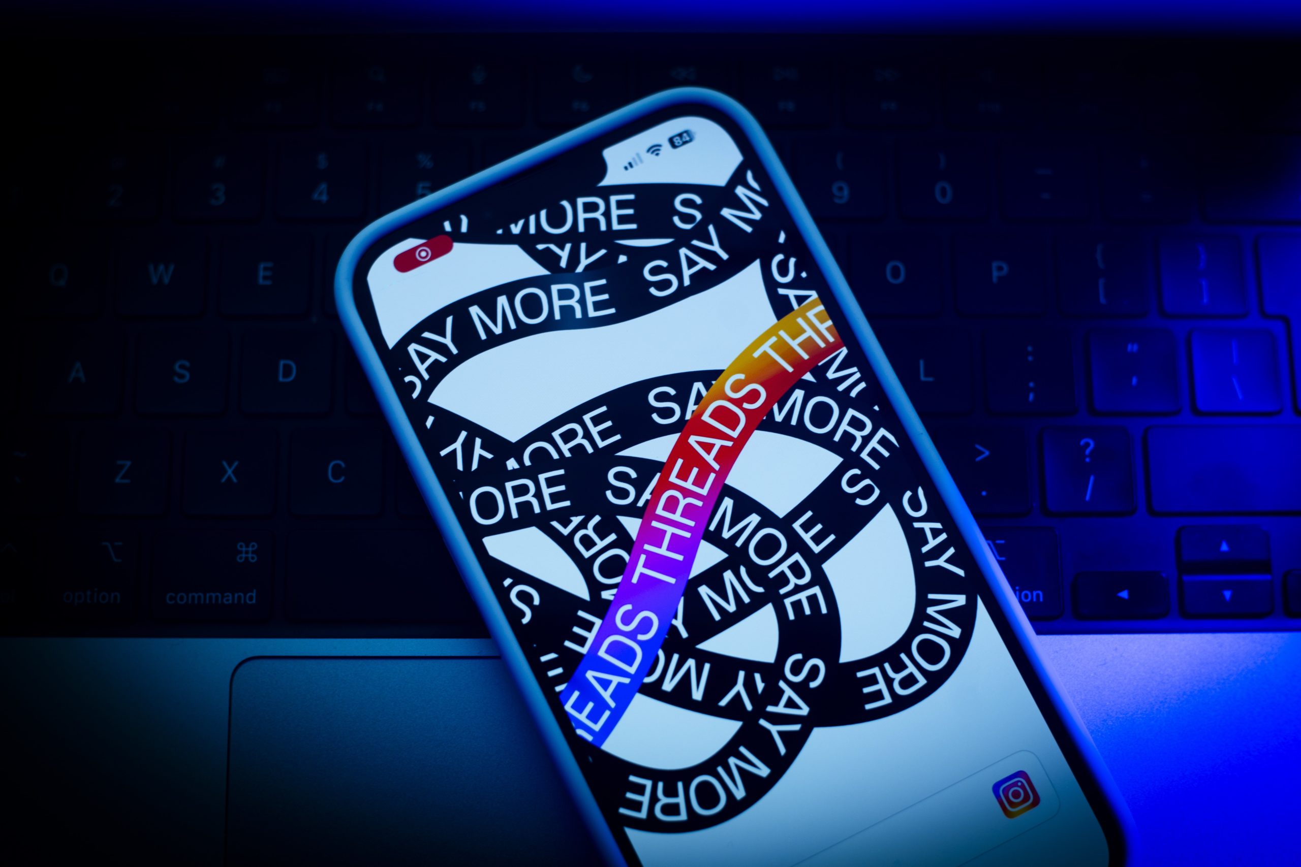 iPhone resting on a laptop keyboard.