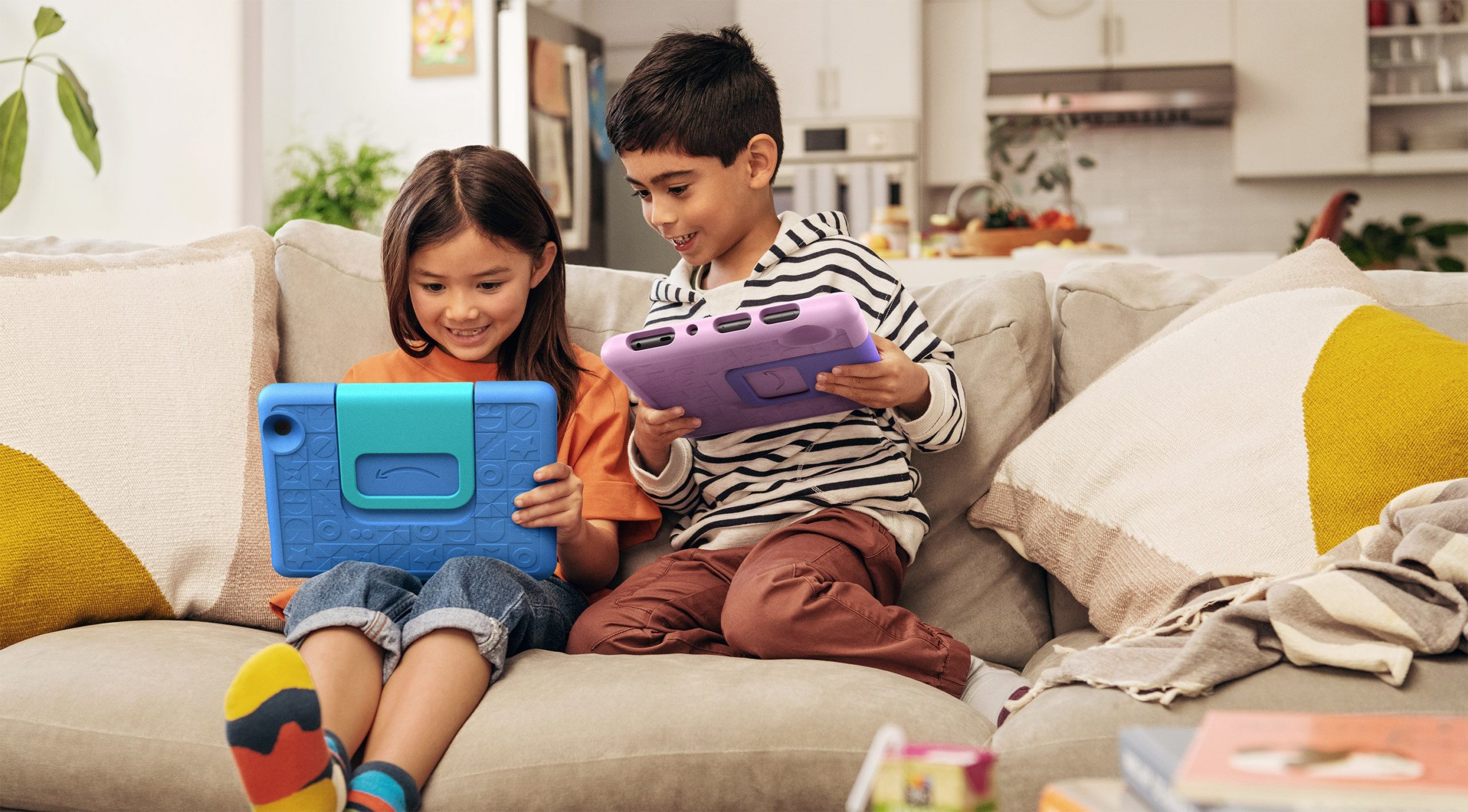 Two kids playing with Amazon Fire HD 10 Kids tablets
