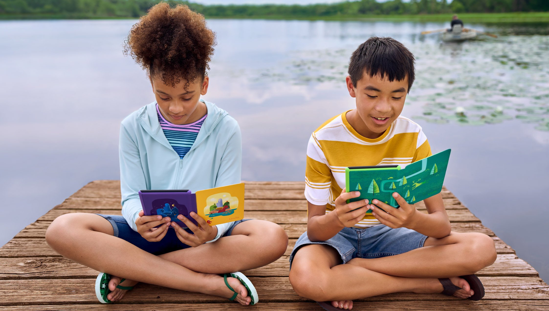 Two kids reading Kindles