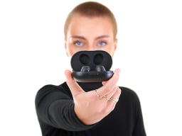 woman holding earbuds in case