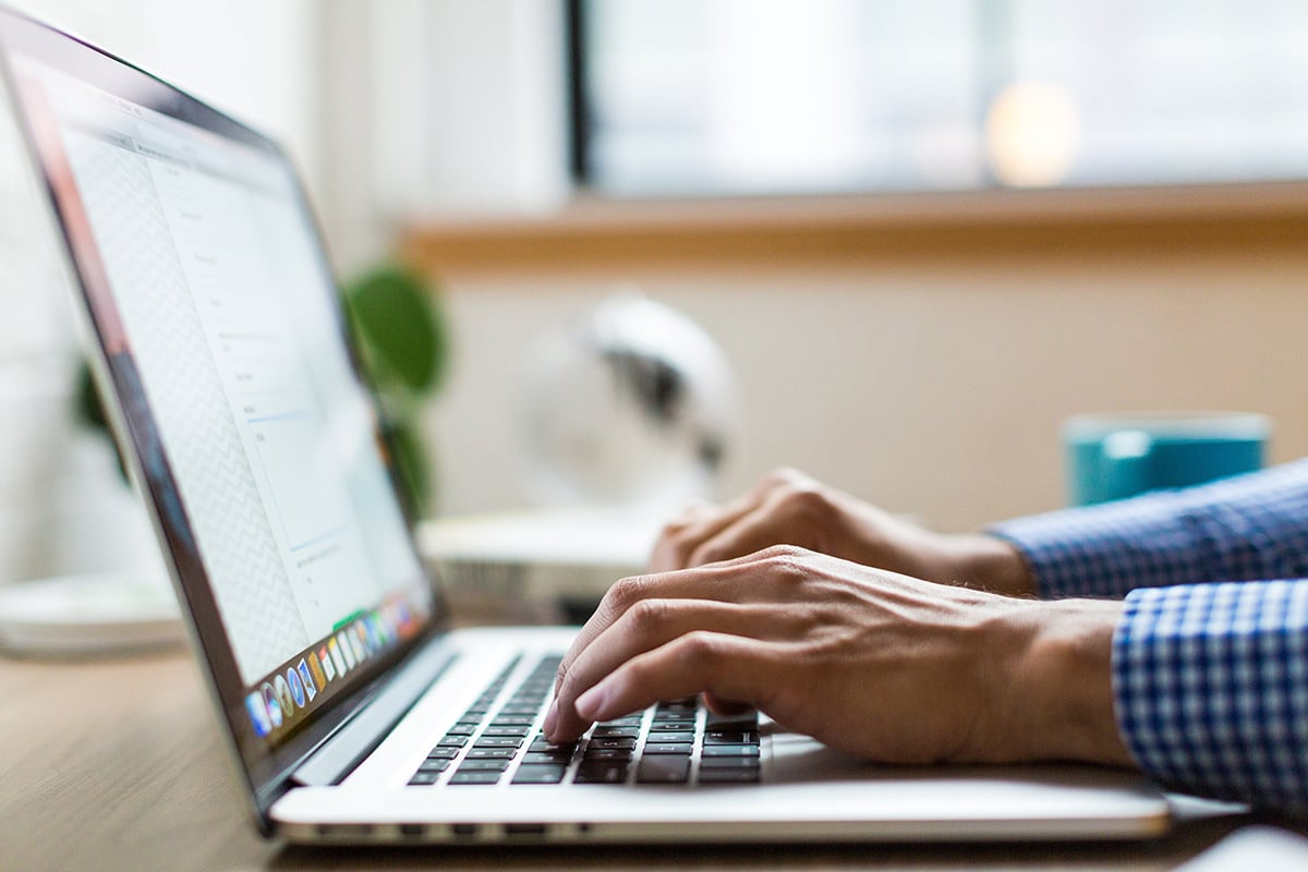 person typing on a laptop