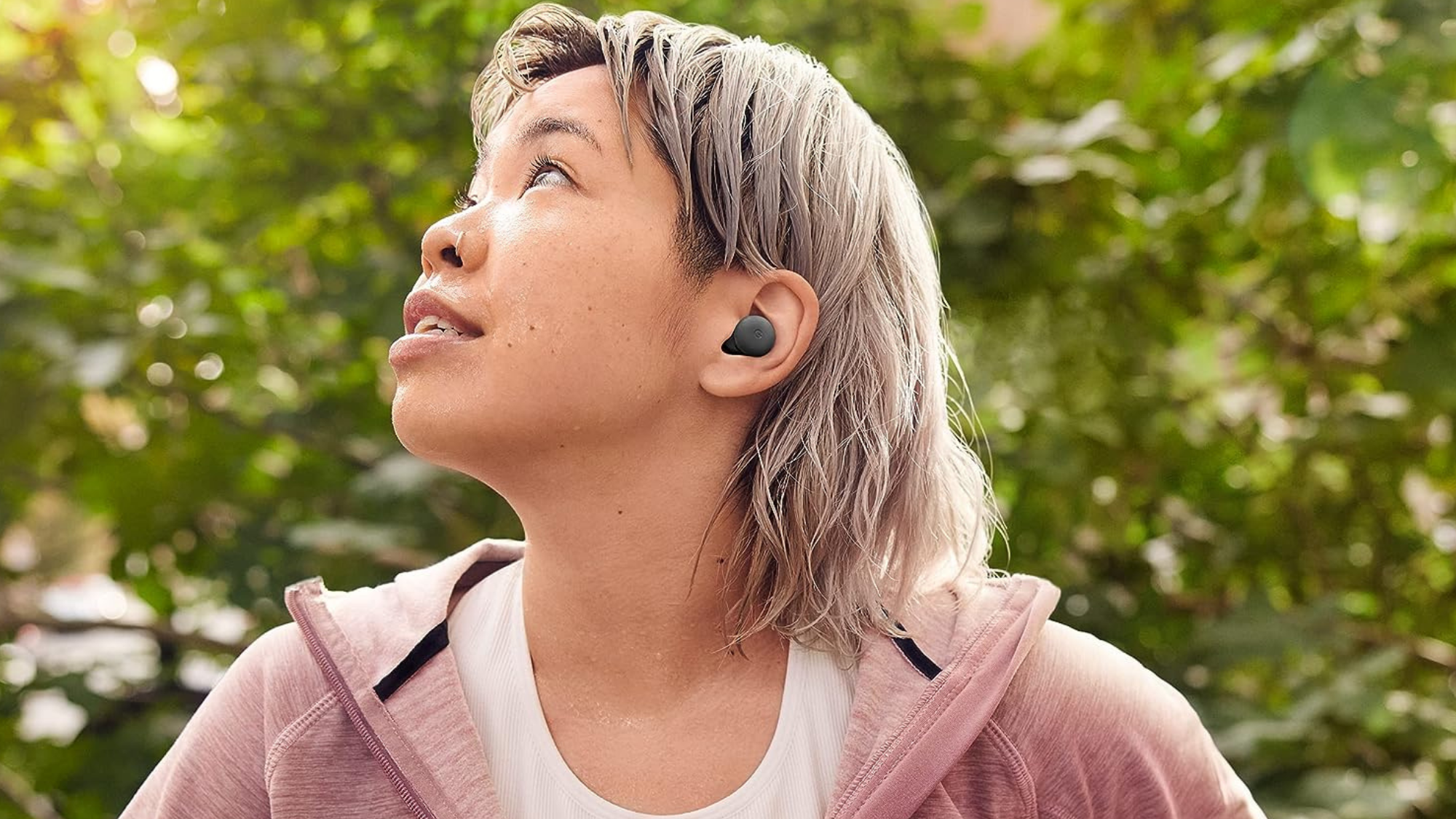 person in a red jacket wearing google pixel buds a-series