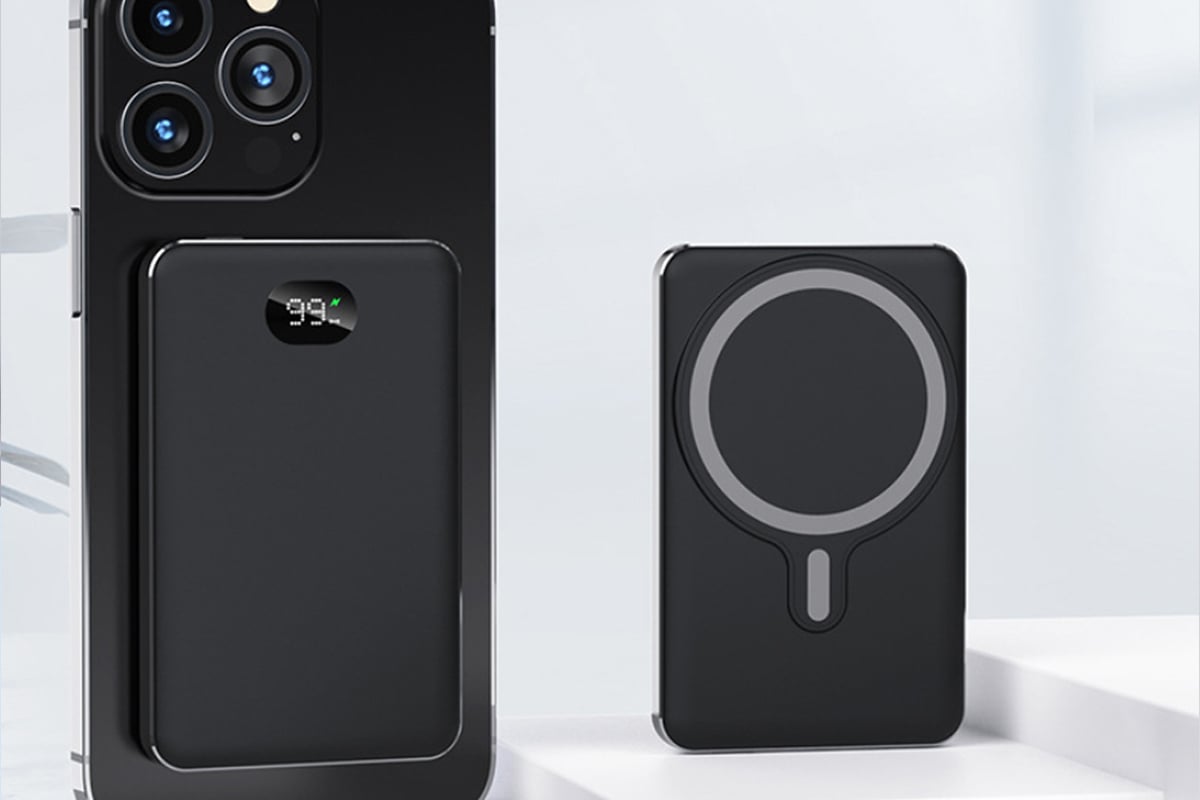 The Speedy Mag Wireless Charger for iPhone shown in a black color next to an accompanying phone. 