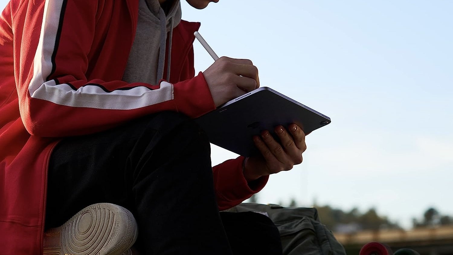 person working on ipad air with apple pencil