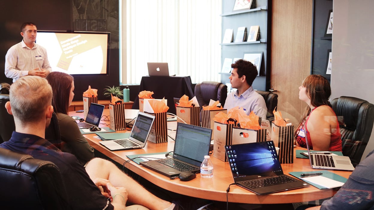 Group of colleagues sat around desk