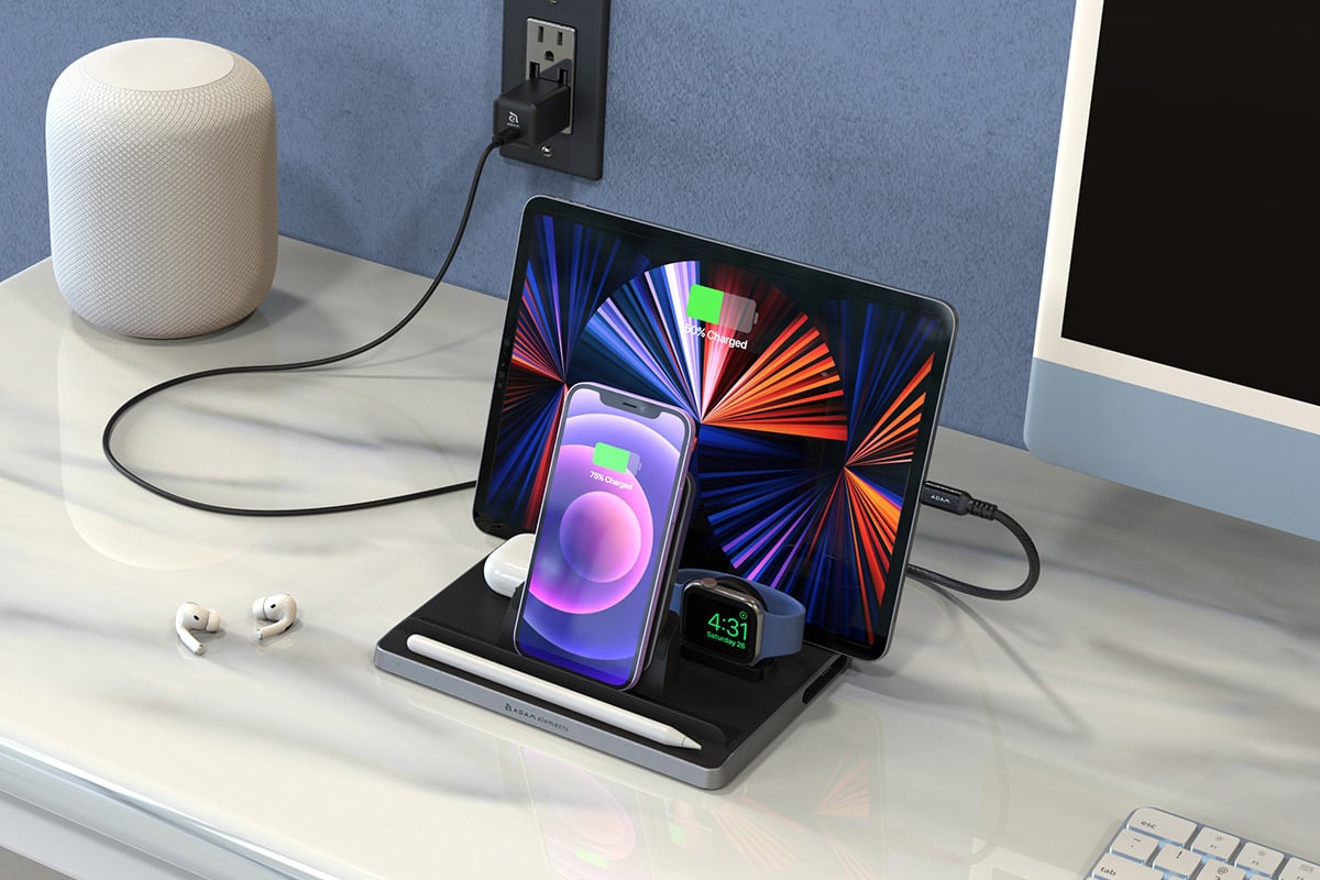The OMNIA Q5 Five-in-One Wireless Charging Station shown powering up devices like a phone and an iPad while standing on a desk.