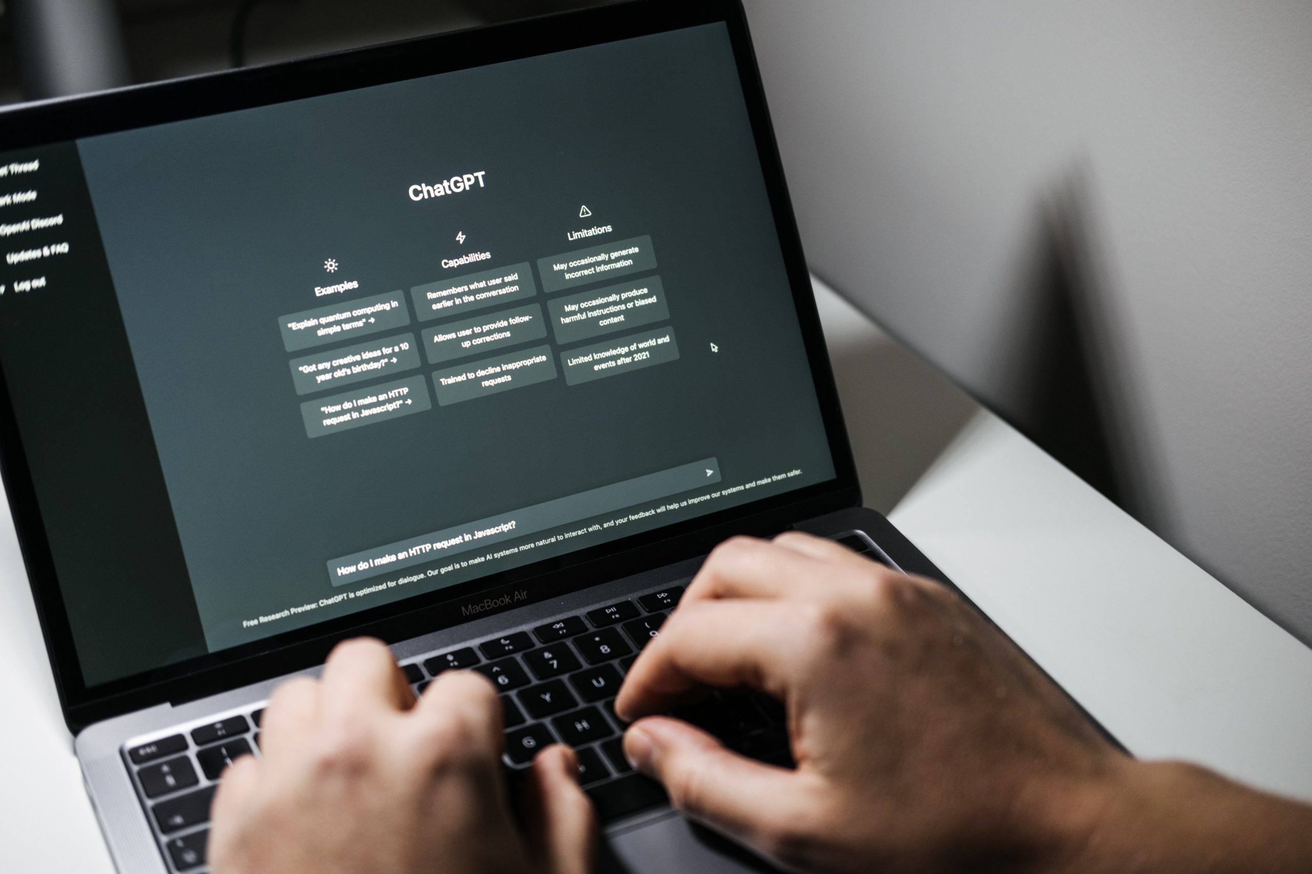 hands typing on ChatGPT on a laptop 