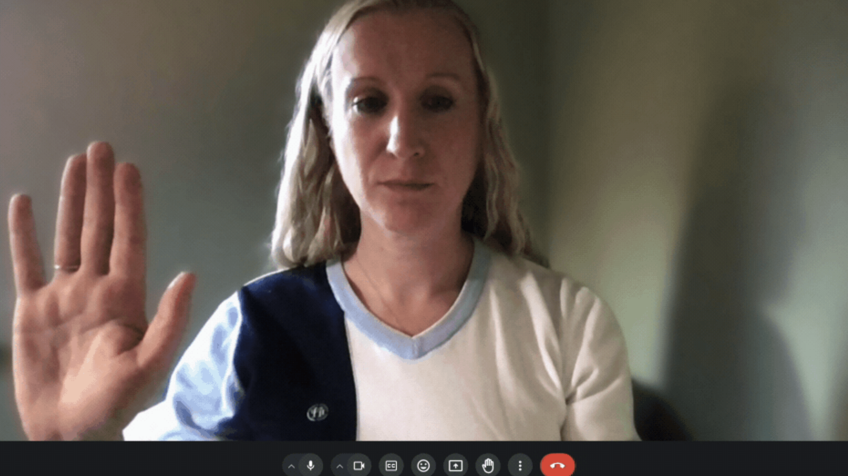Woman raising her hand during a Google Meet call