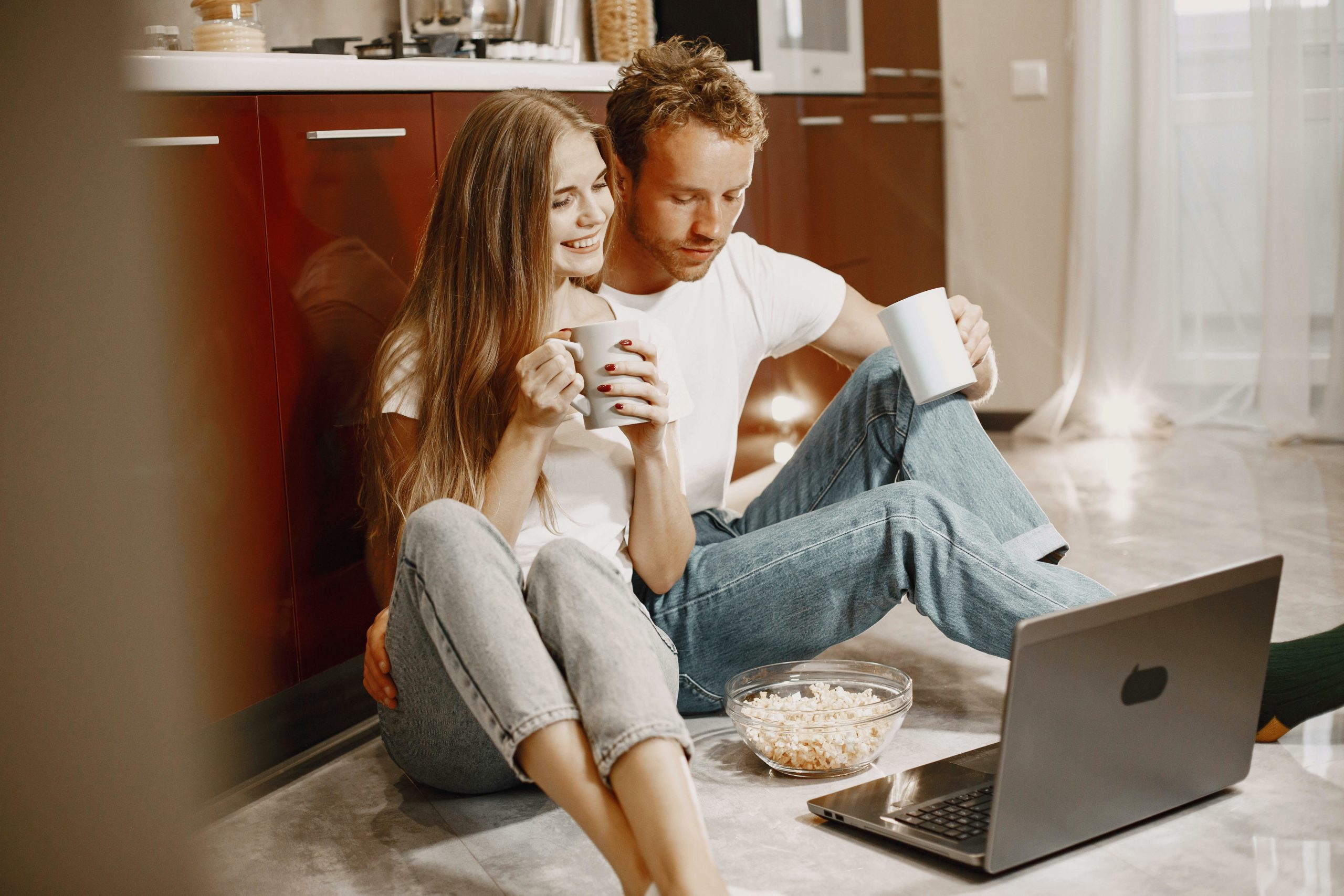 Couple smiling at laptop