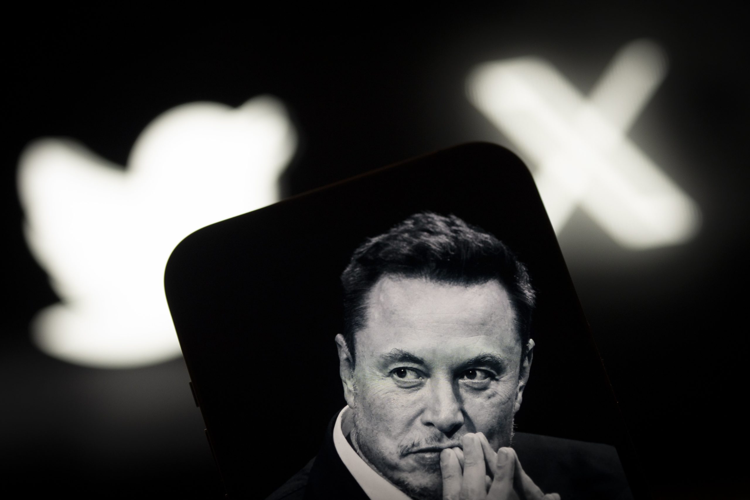 Elon Musk with X and Twitter logos