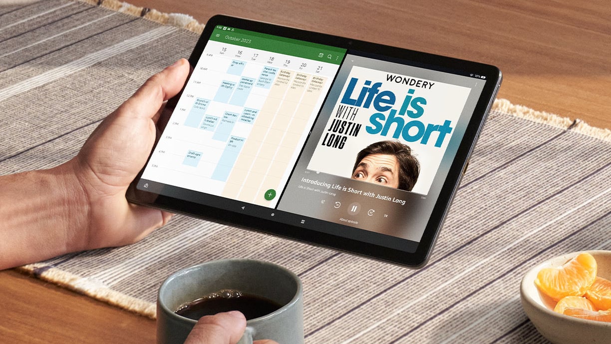 man listening to podcast on fire HD tablet at kitchen table