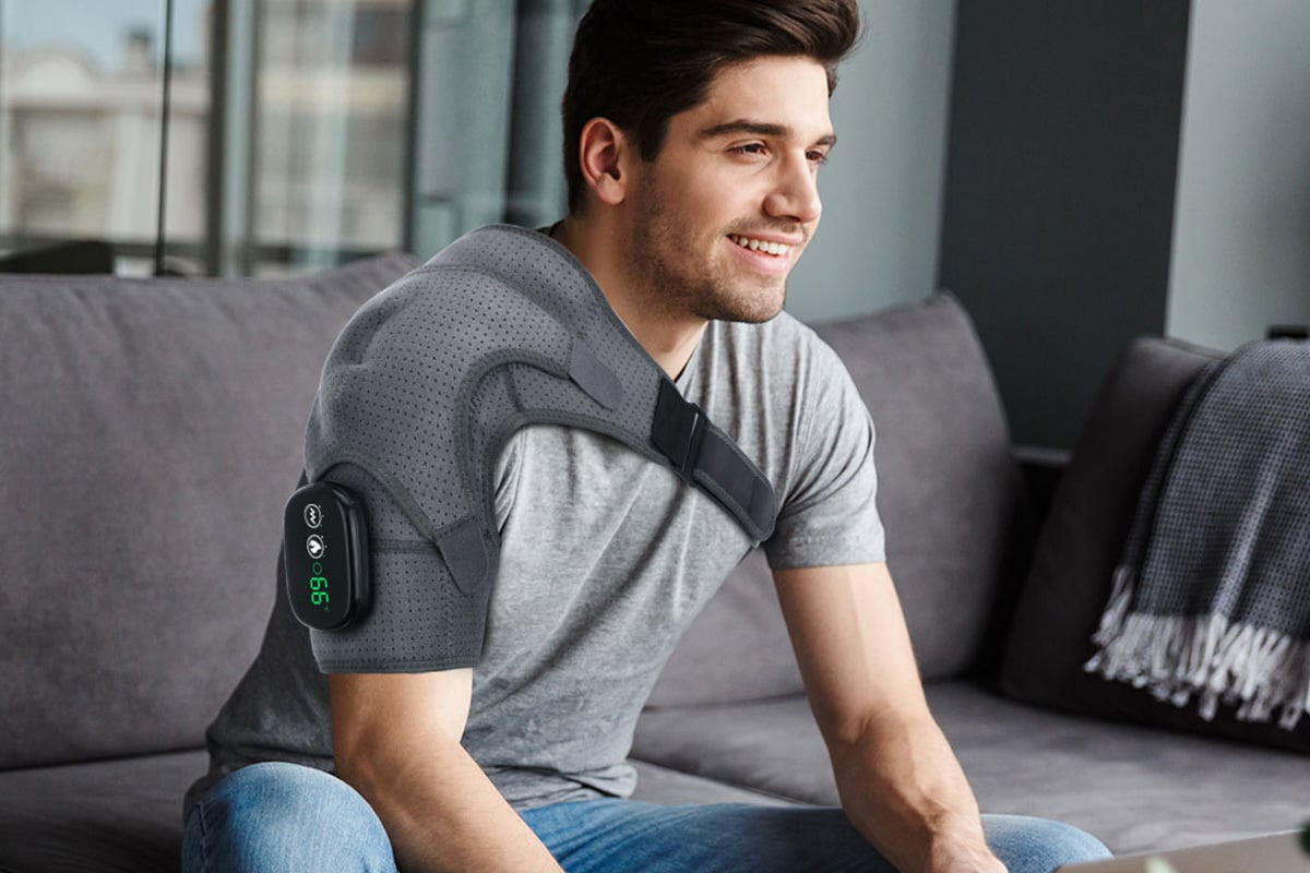 man wearing the shoulder massager