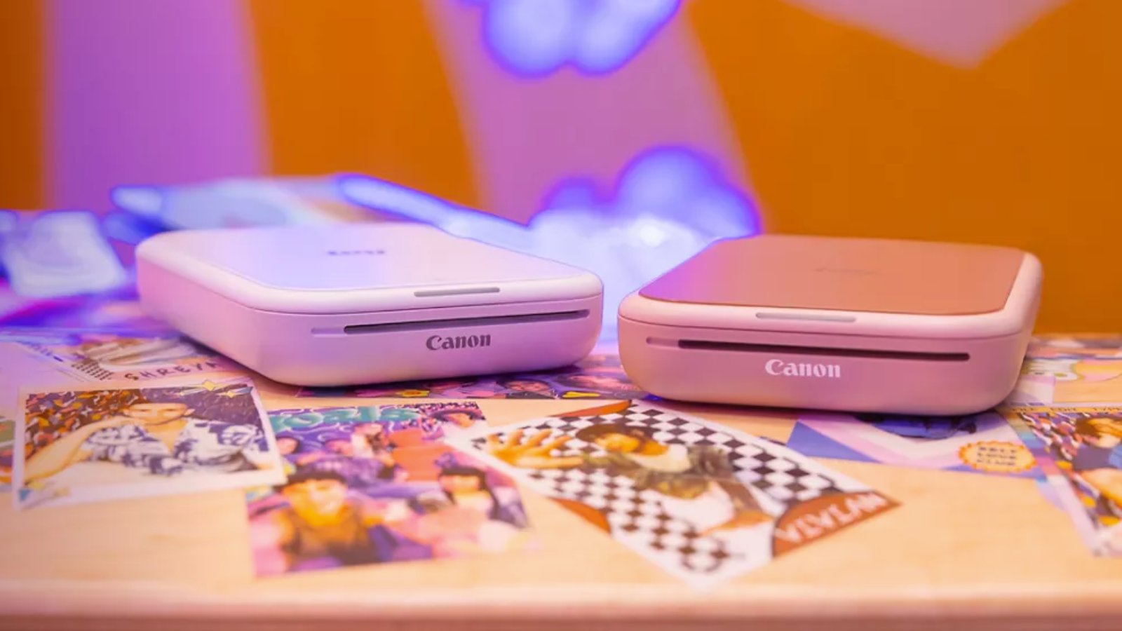 Canon Ivy 2 Mini Photo Printers with printed photos and vibrant background