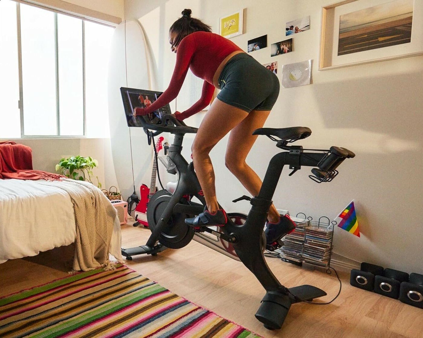 a person rides a Peloton bike indoors