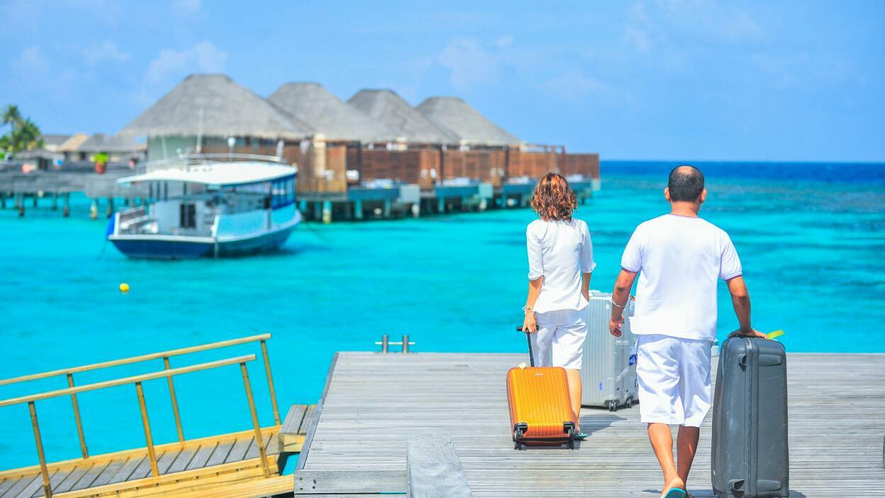 Couple walking with suitcases