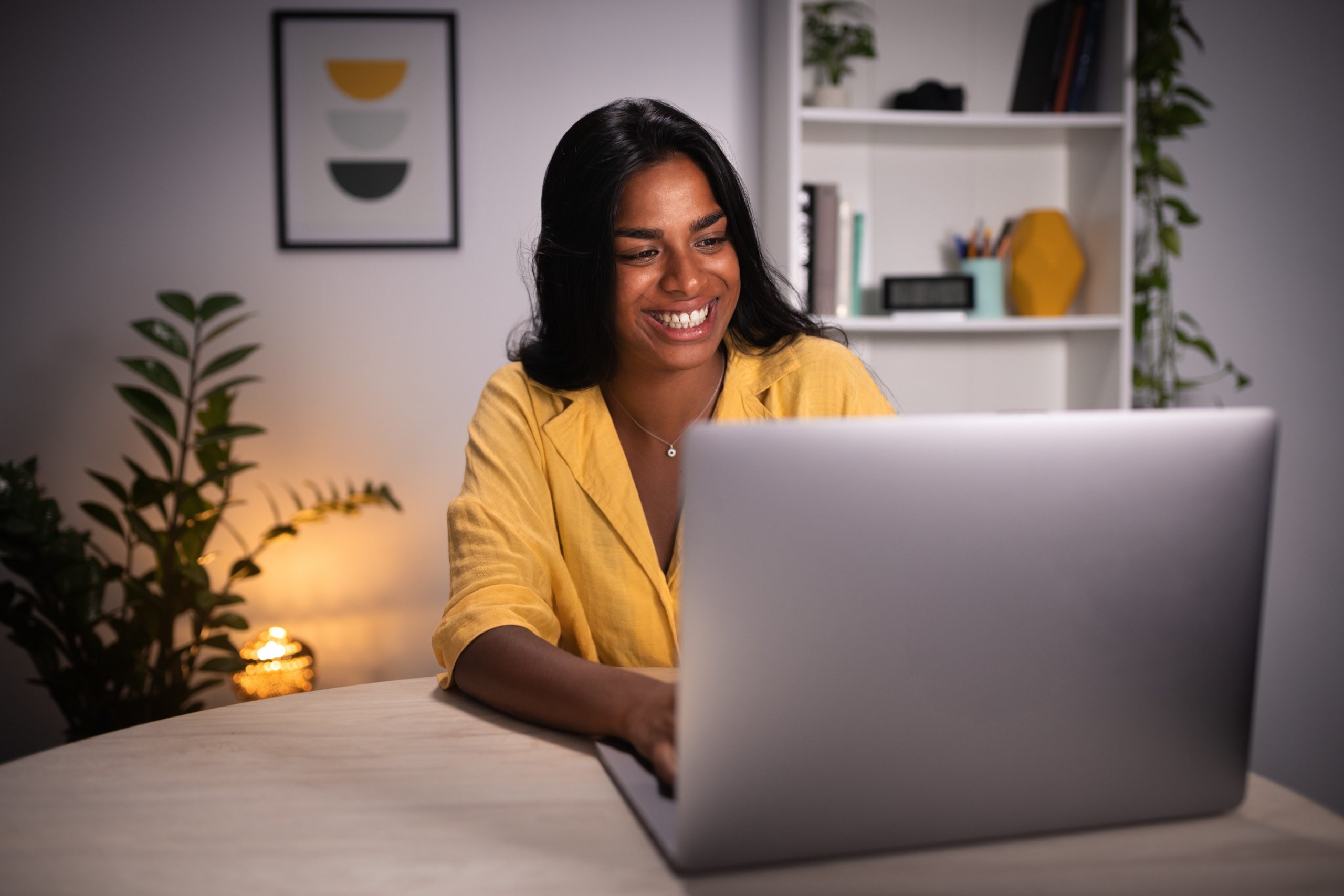 Woman smiling at computer.