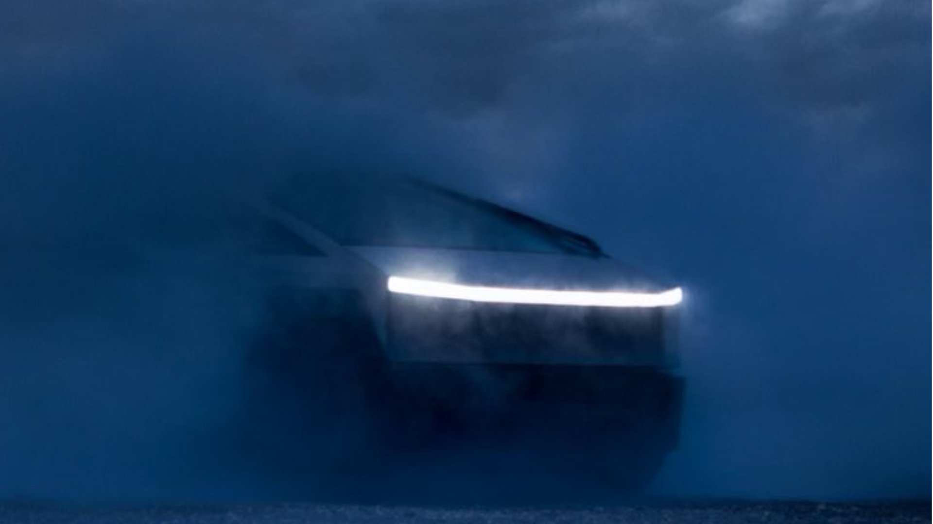 Tesla Cybertruck emerging from the dark.