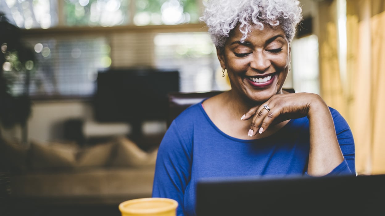 Woman smiling at laptop