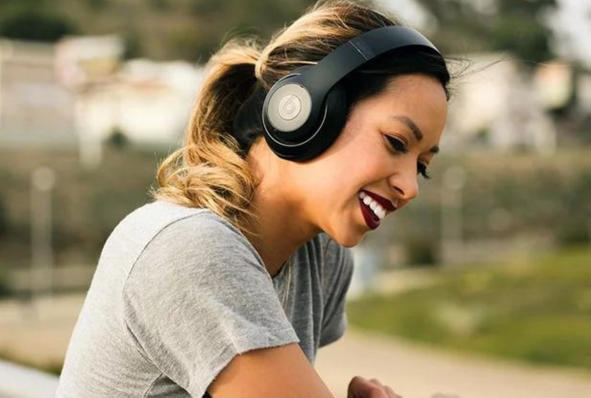 woman listening to music on beats headphones 