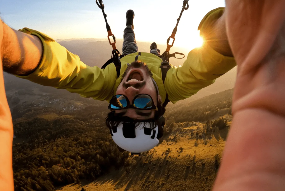 Man skydiving upside-down in the sunlight 