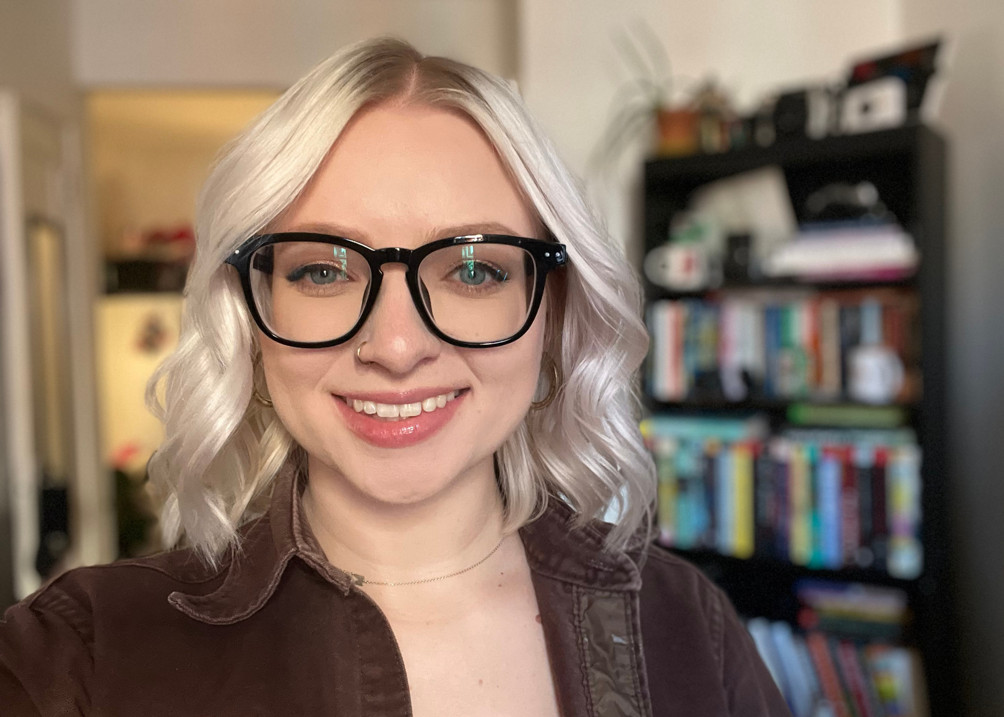 blonde woman wearing black frame glasses