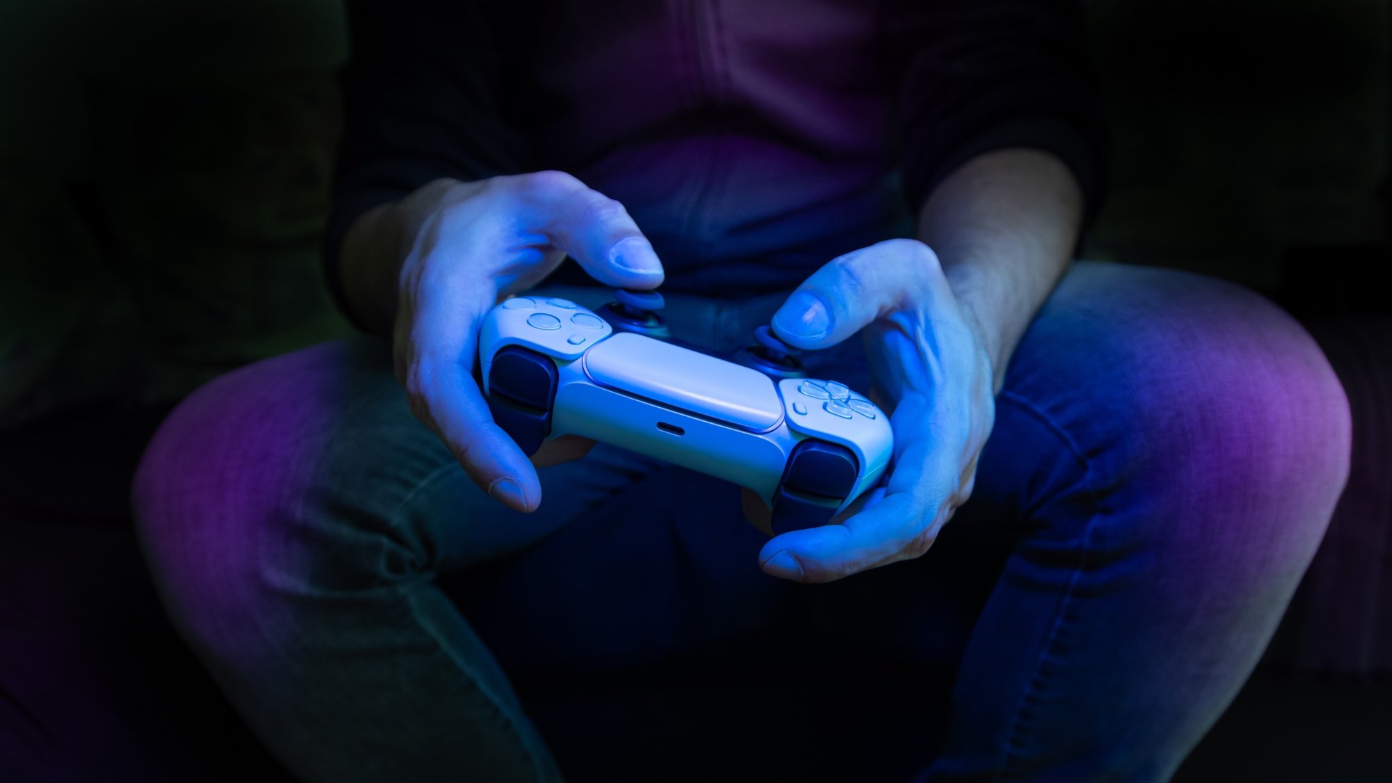 Man playing with PS5 controller