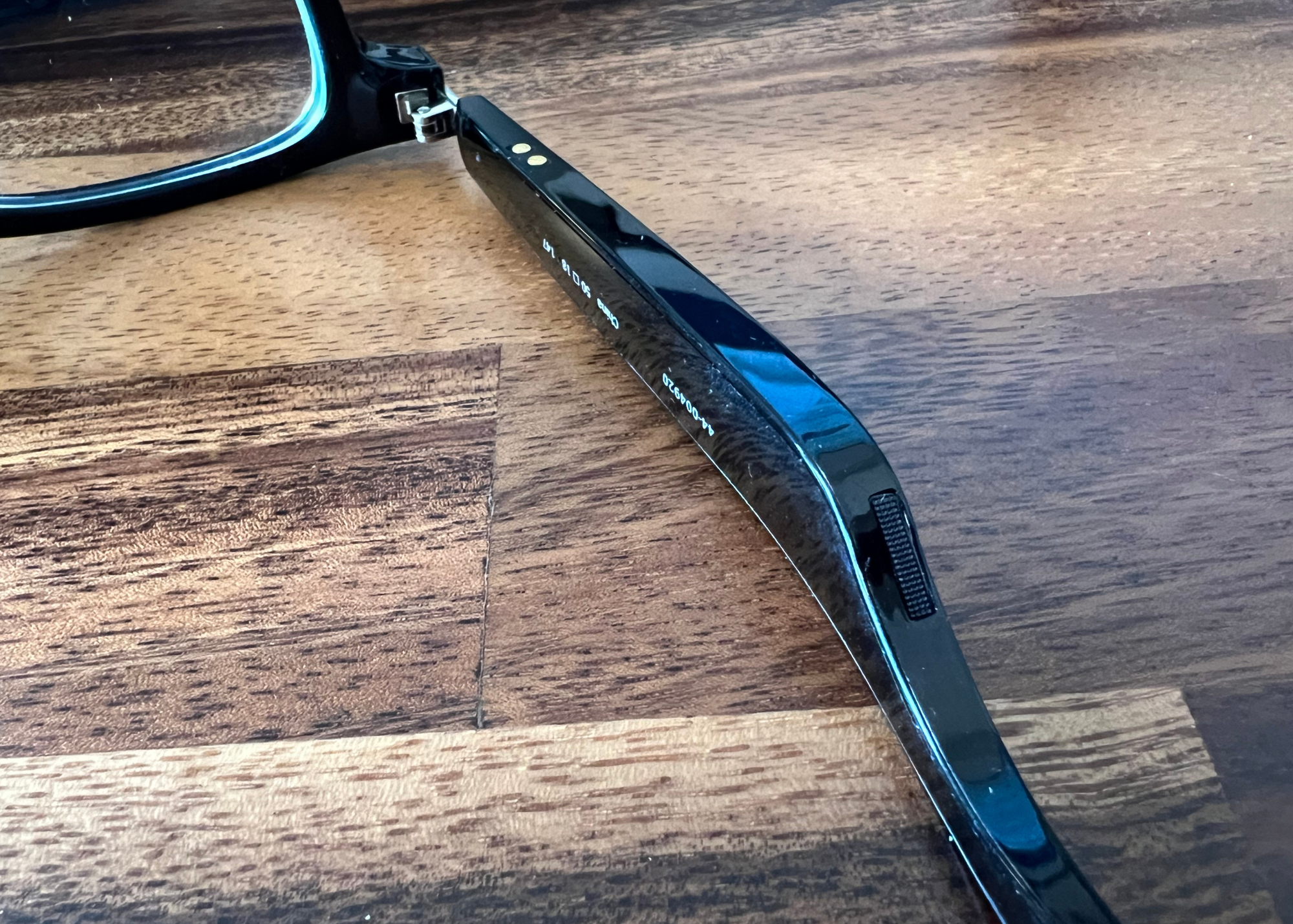 arm of glasses with small speaker embedded