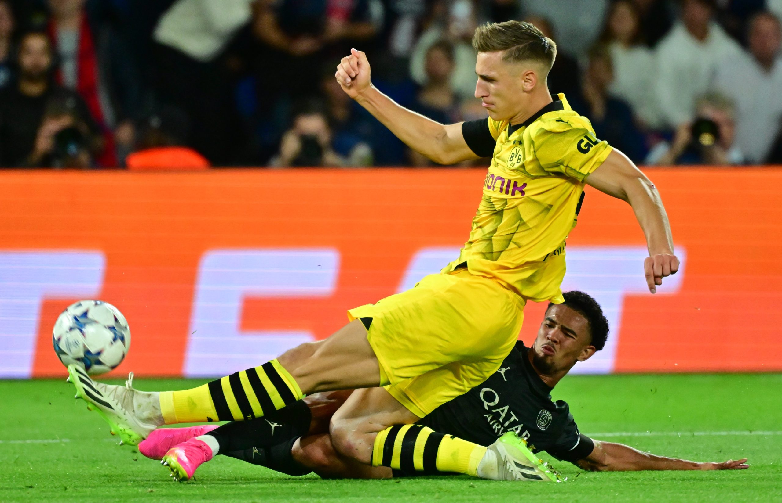 Nico Schlotterbeck of Borussia Dortmund tackles the ball