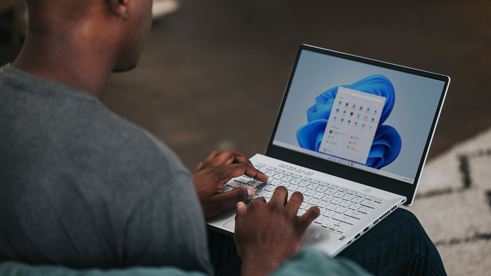 man using laptop with Microsoft Office apps