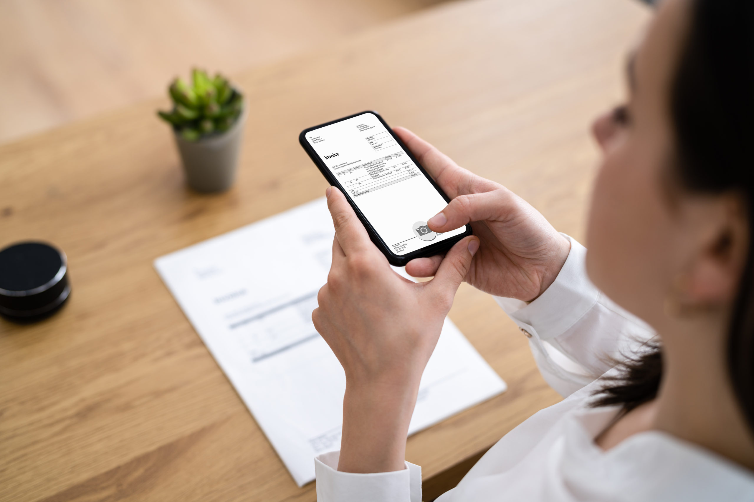 woman taking a picture of document