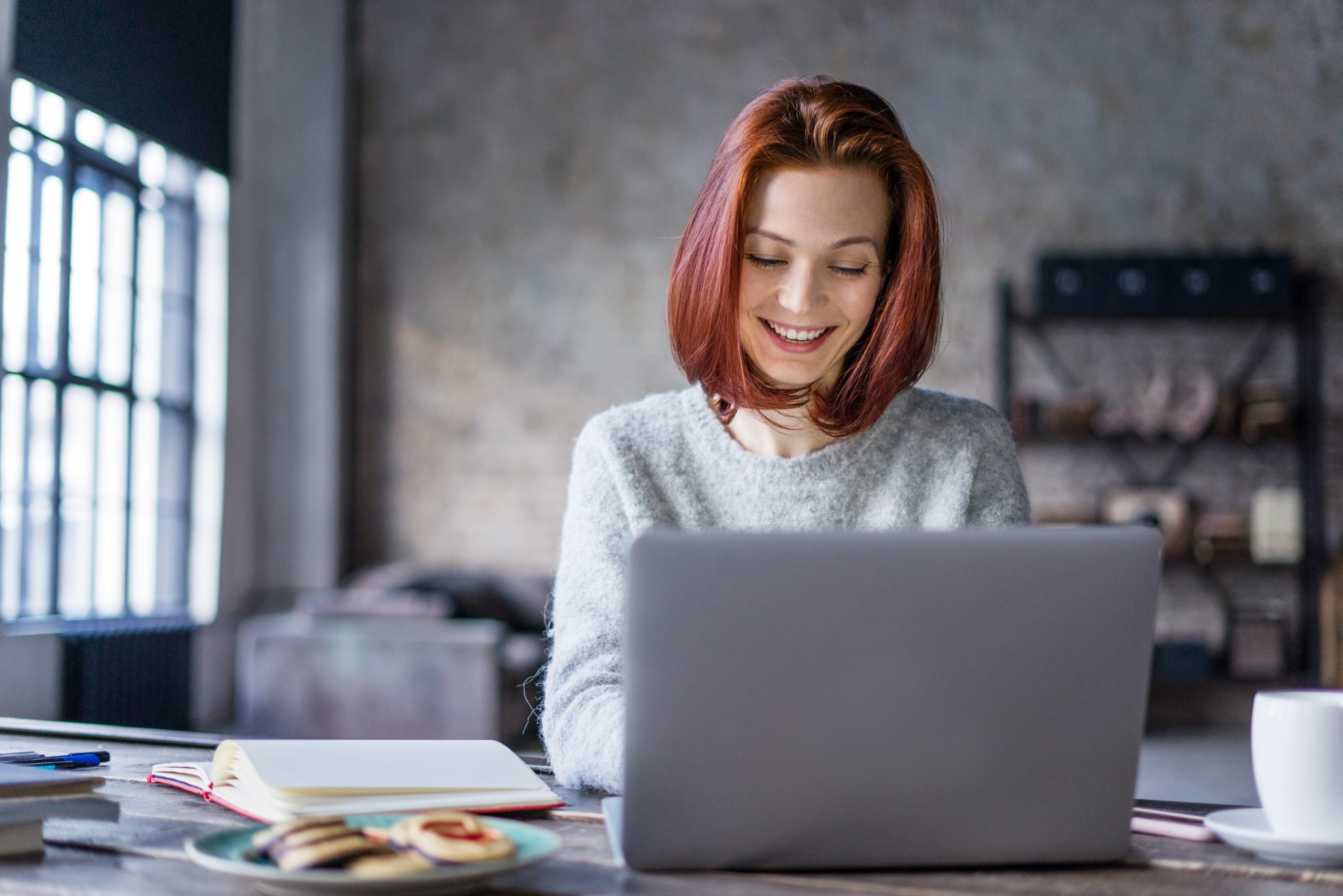 person writing on laptop