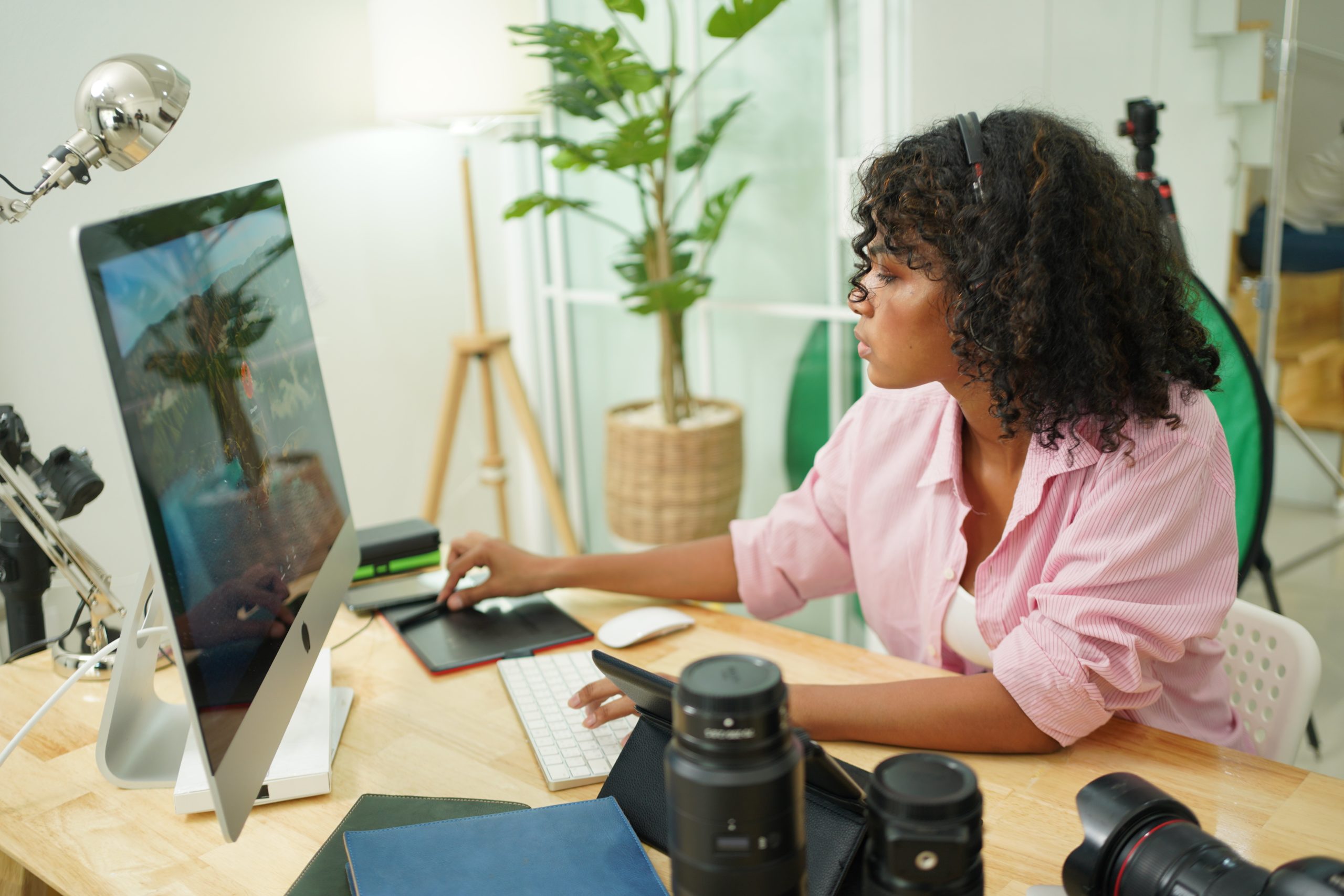 woman editing photos on desktop computer