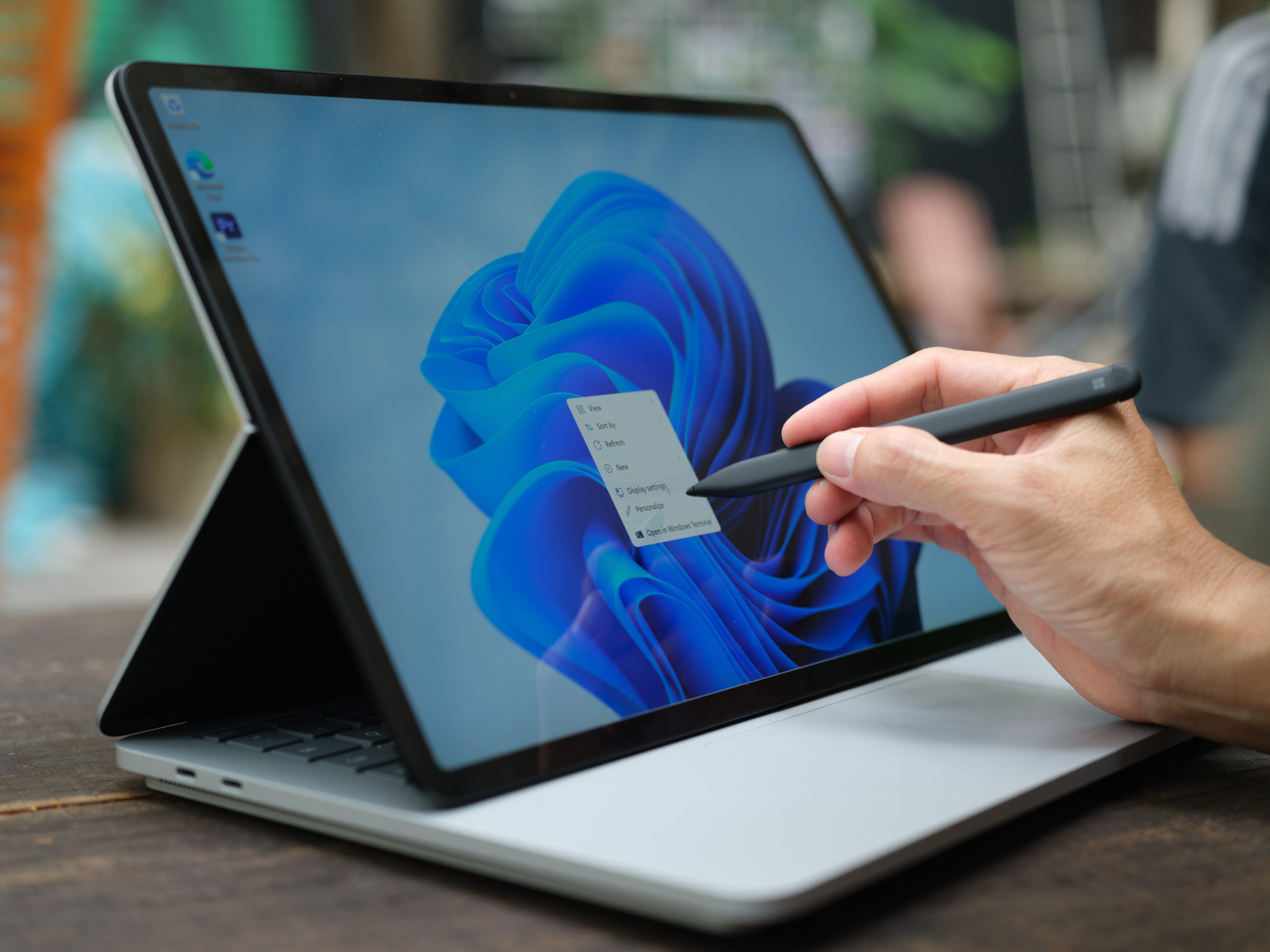 person using touchscreen laptop