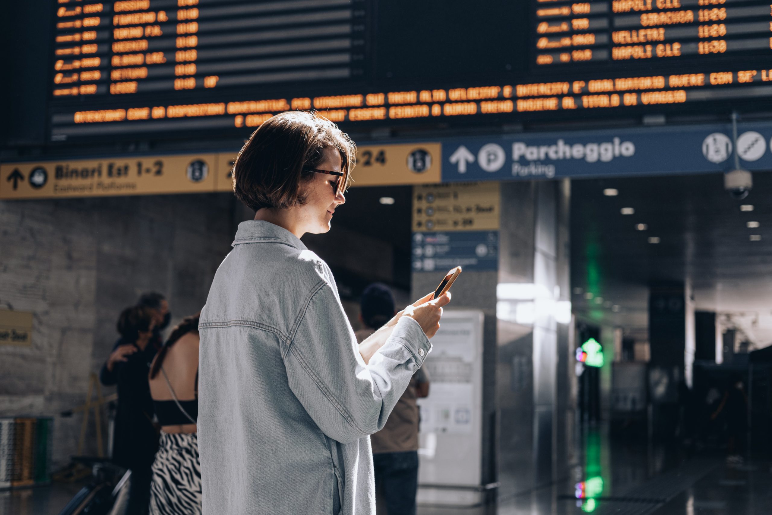 person using phone in an airport