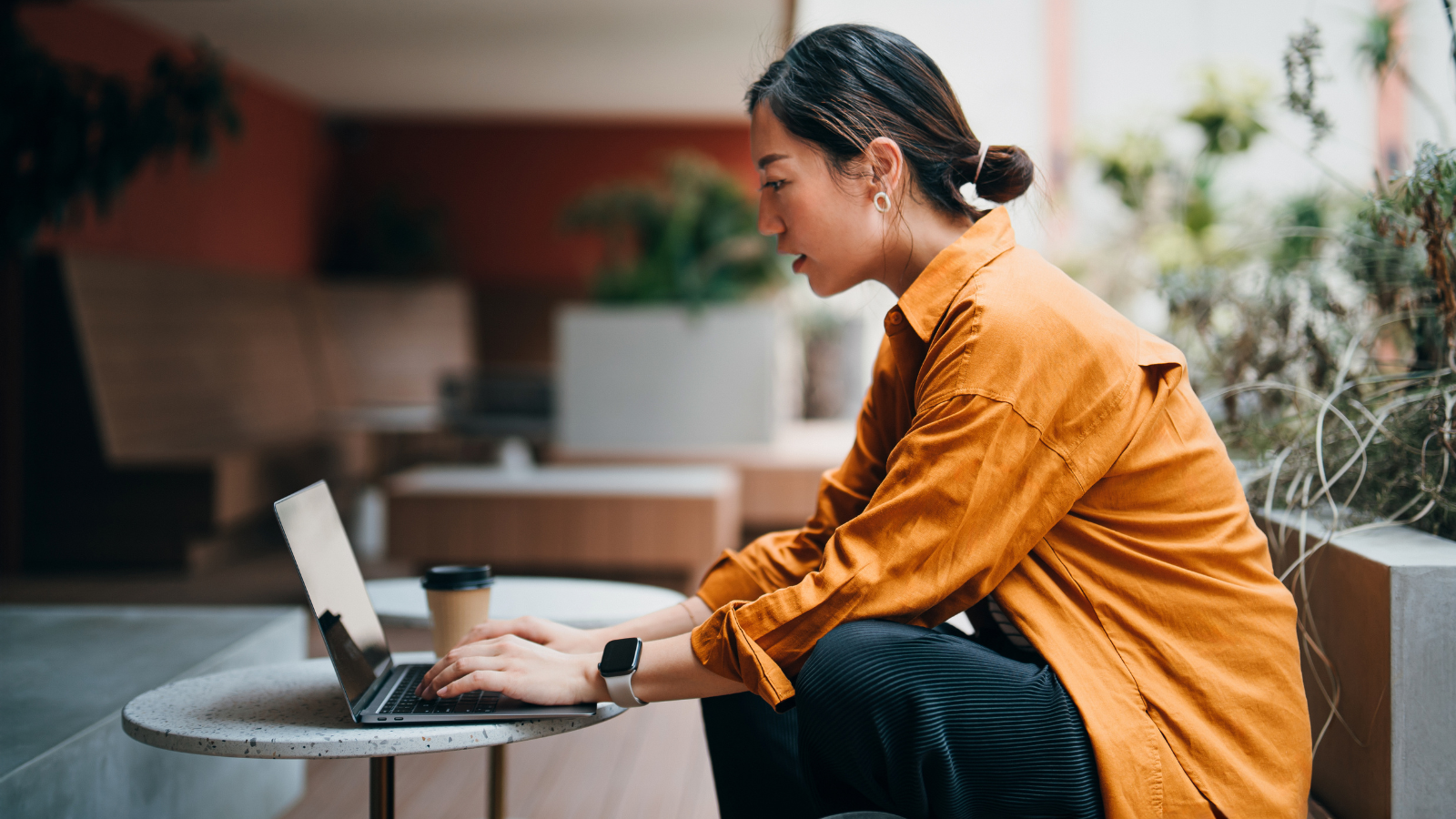 woman working on laptop at a coffee shop