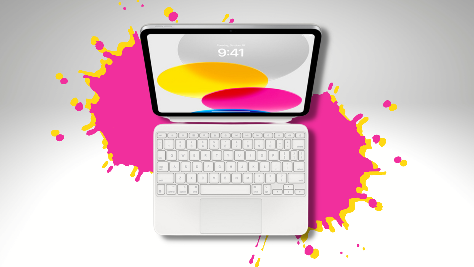 Apple Magic Keyboard connected to iPad with pink and yellow splatters in background